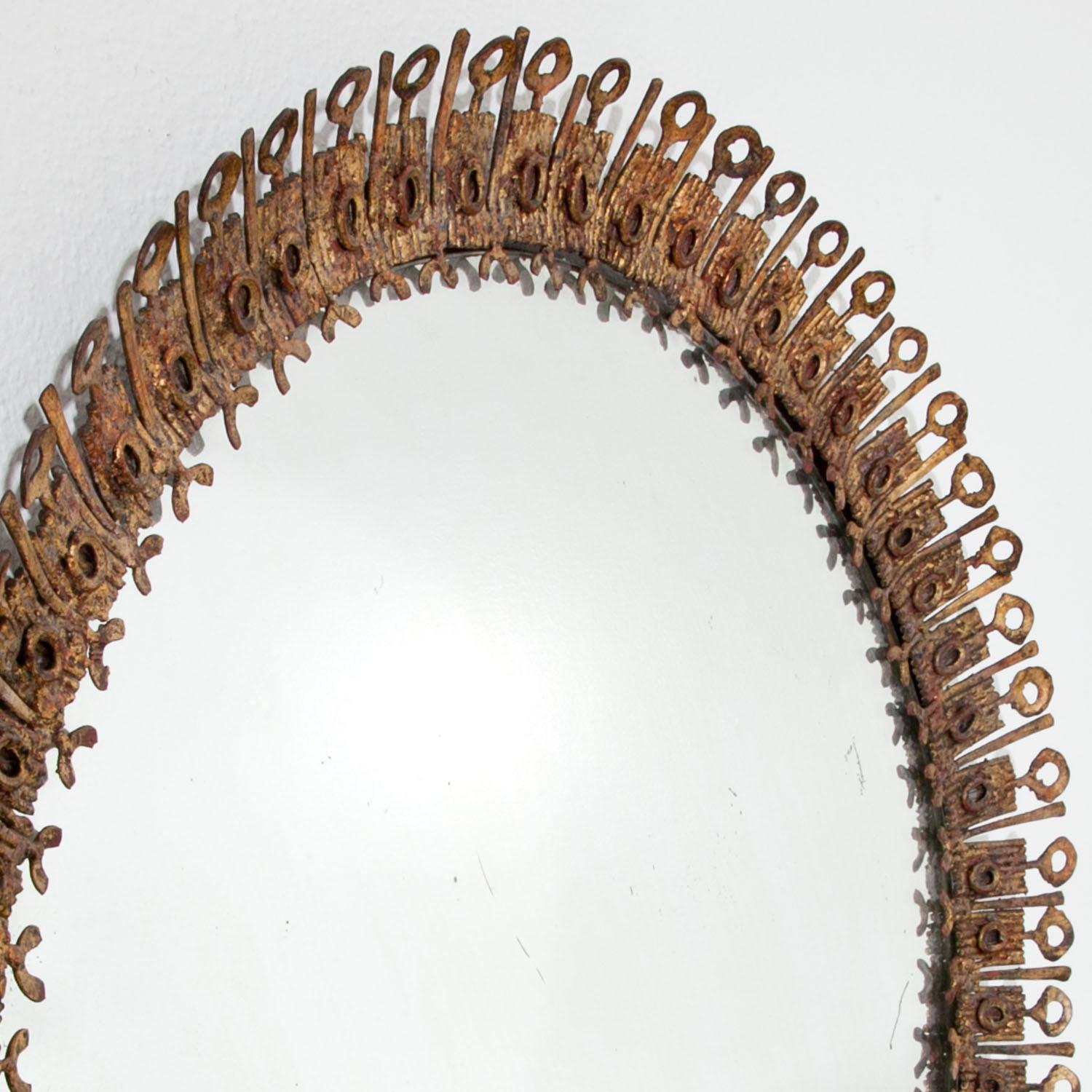 Round brutalist sunburst mirror with an iron frame.