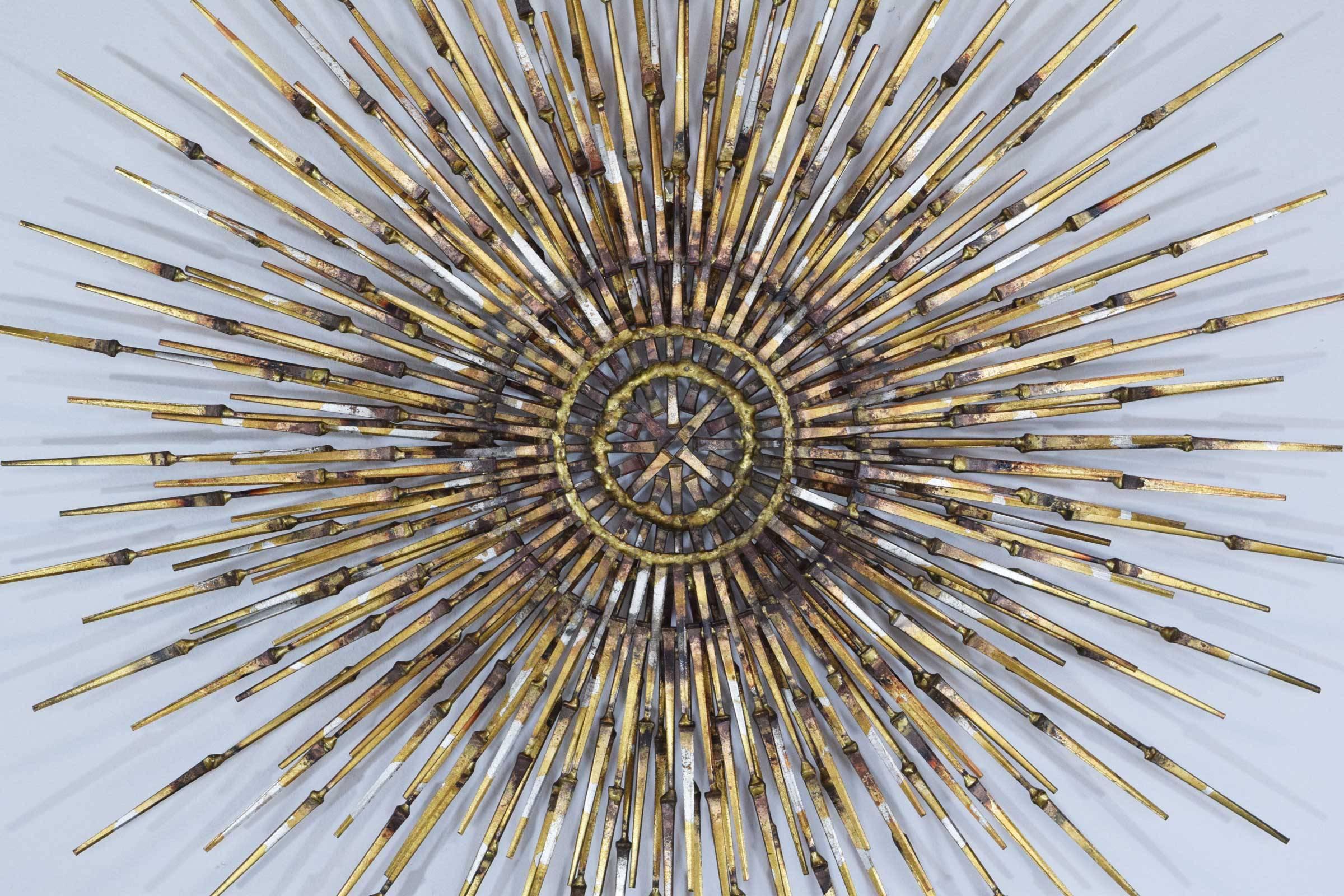 Large sunburst wall sculpture by William Bowie, lots of interest, beautiful mix of colors. Two layers.
