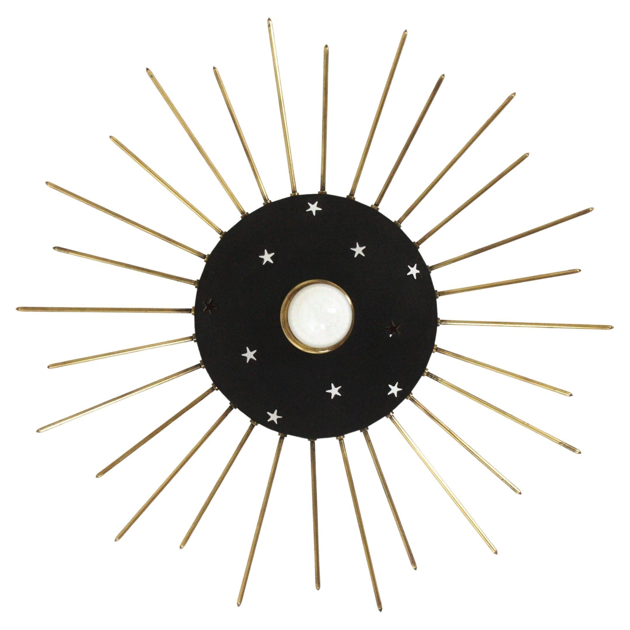 Italian Black Lacquered and Gilt Metal Sunburst Flush Mount
Black lacquered metal and brass sunburst flush mount light fixture or suspension light. Italy, 1950s.
This eye-catching ceiling lamp features a black lacquered metal shade adorned by star