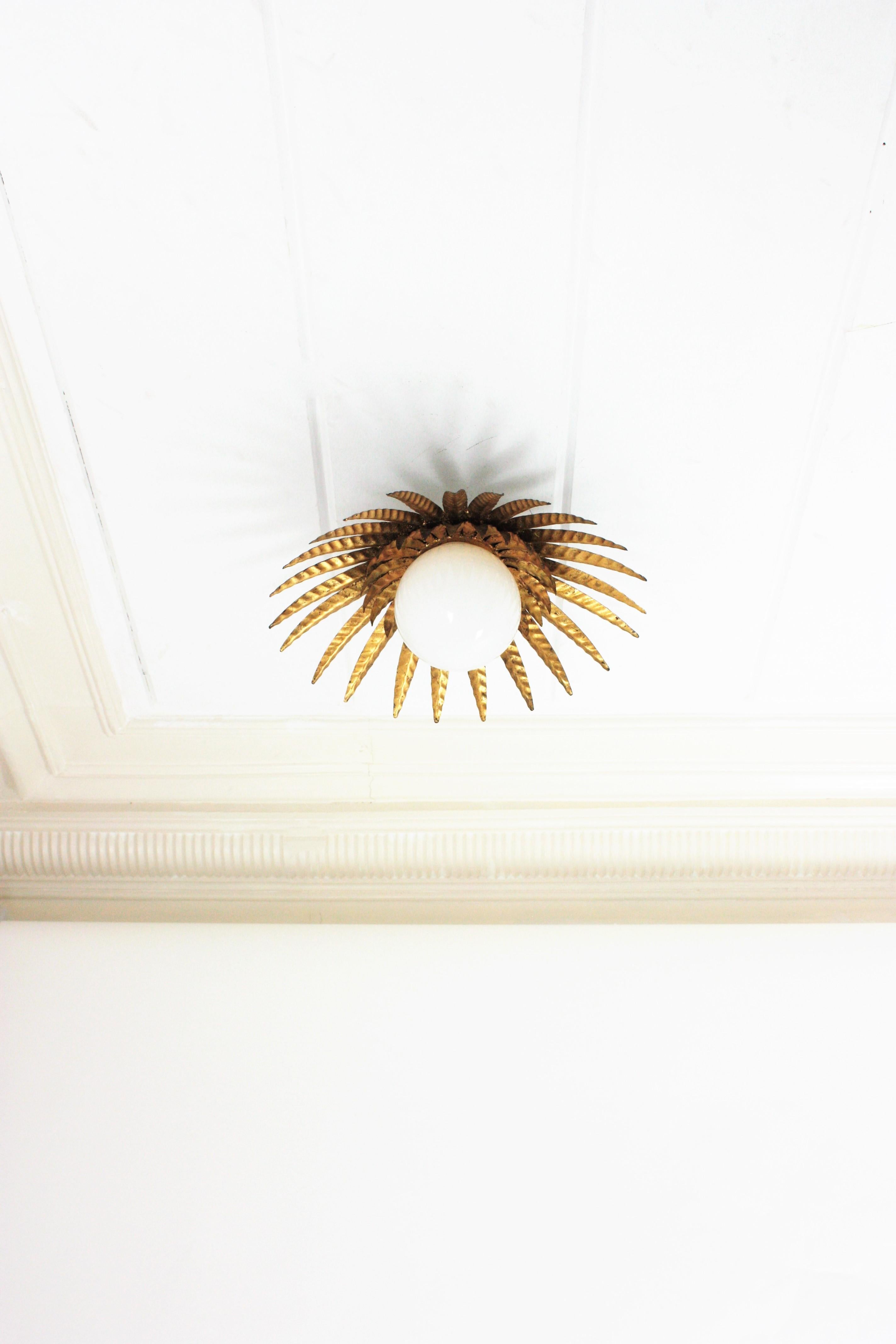 Sunburst Ceiling Light Fixture in Gilt Iron with Milk Glass Globe  In Good Condition For Sale In Barcelona, ES