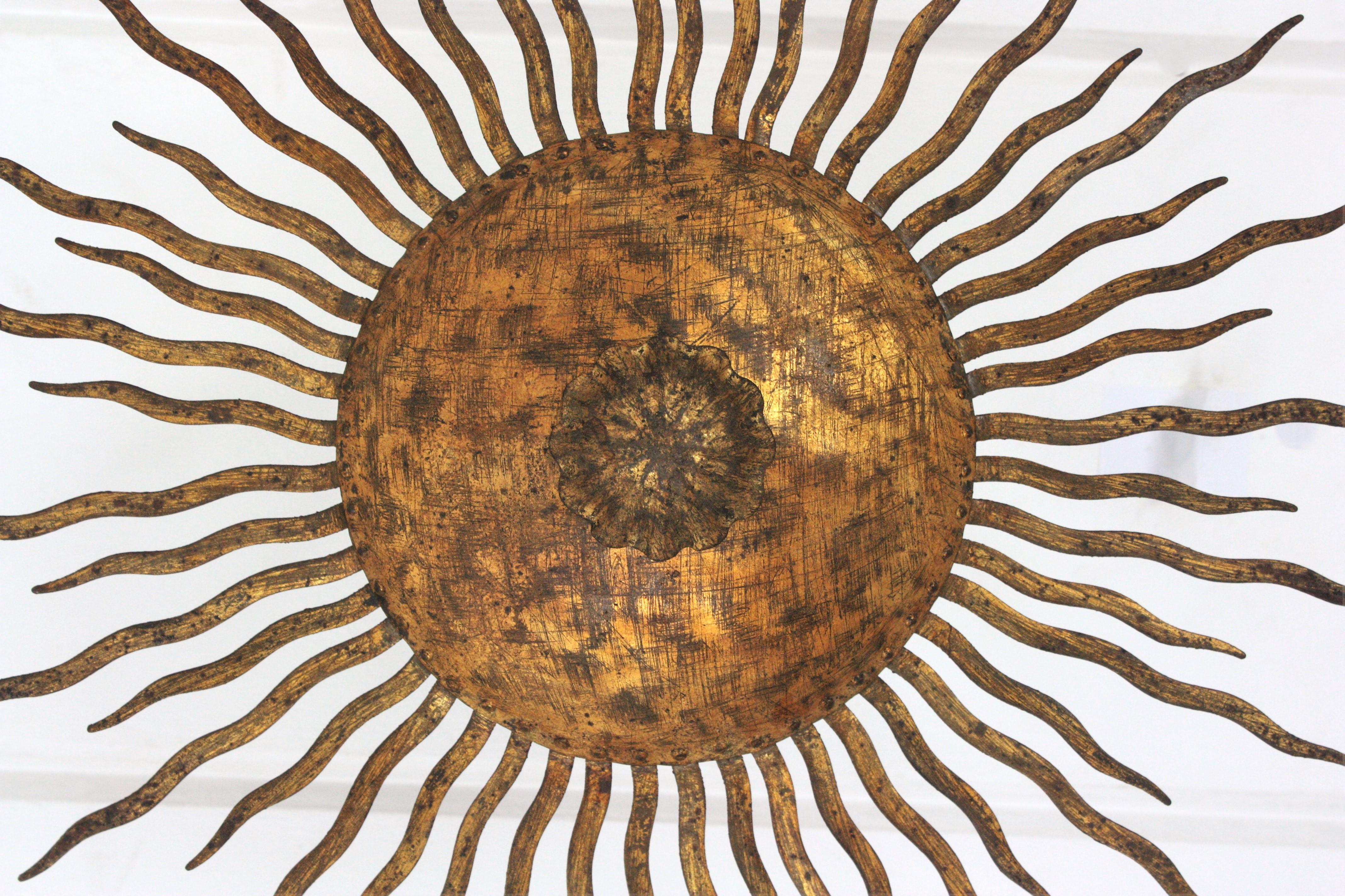 Hammered Sunburst Ceiling Light Fixture or Chandelier with Curly Rays, Gilt Iron For Sale