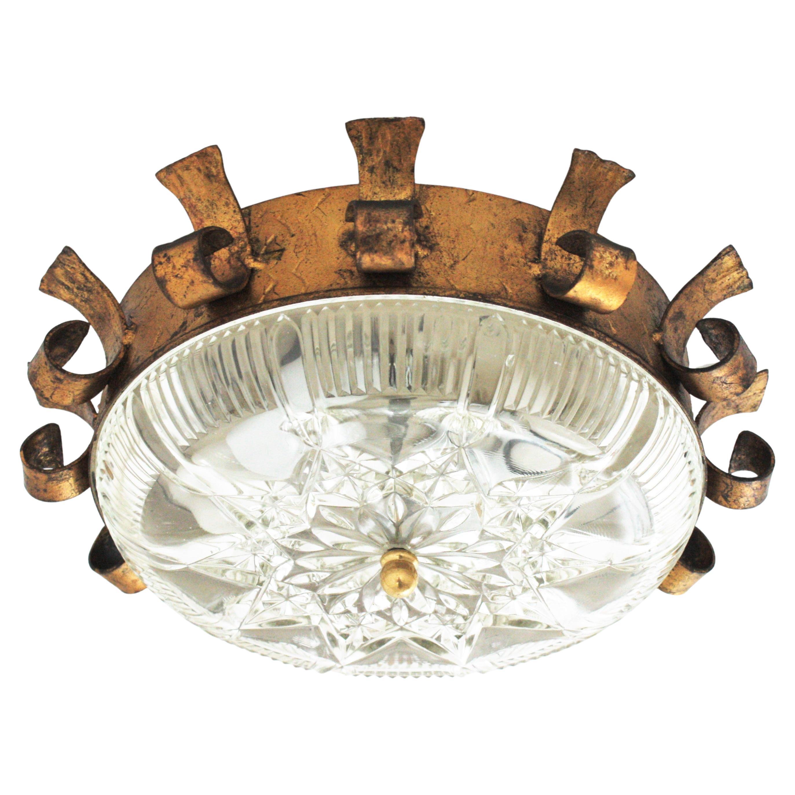 Sunburst Crown Light Fixture, Gilt Iron, Gold Leaf, Pressed Glass
Eye-catching neoclassical style sunburst ceiling light fixture from the Mid-Century Modern period, Spain, 1950s.
This ceiling fixture features a hand forged gilt iron sunburst crown