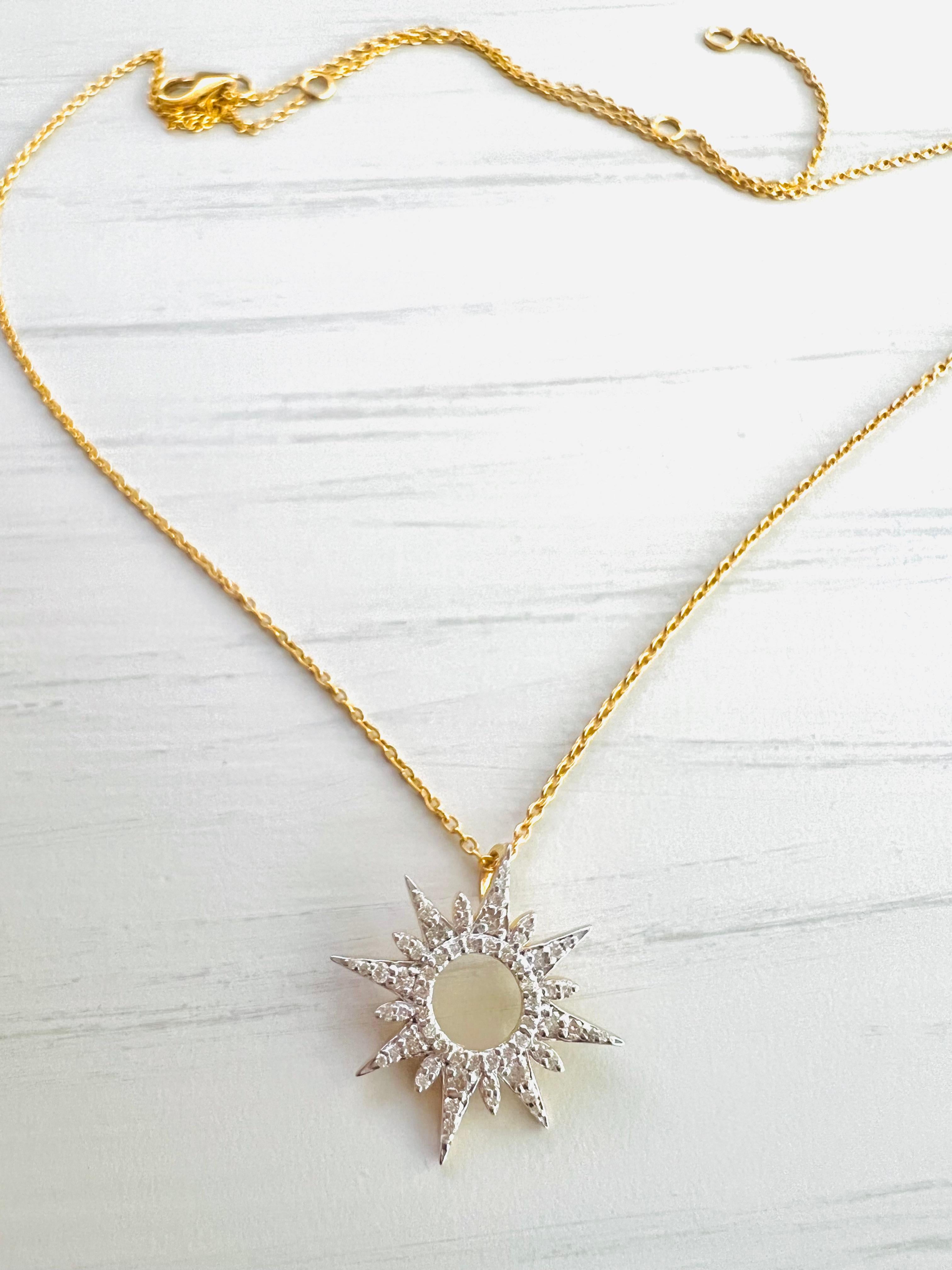 This splendid and captivating sun burst diamond necklace is set with brilliant diamonds in 18k yellow gold. Earrings shown in the pictures are not included and are sold separately. The necklace is 18