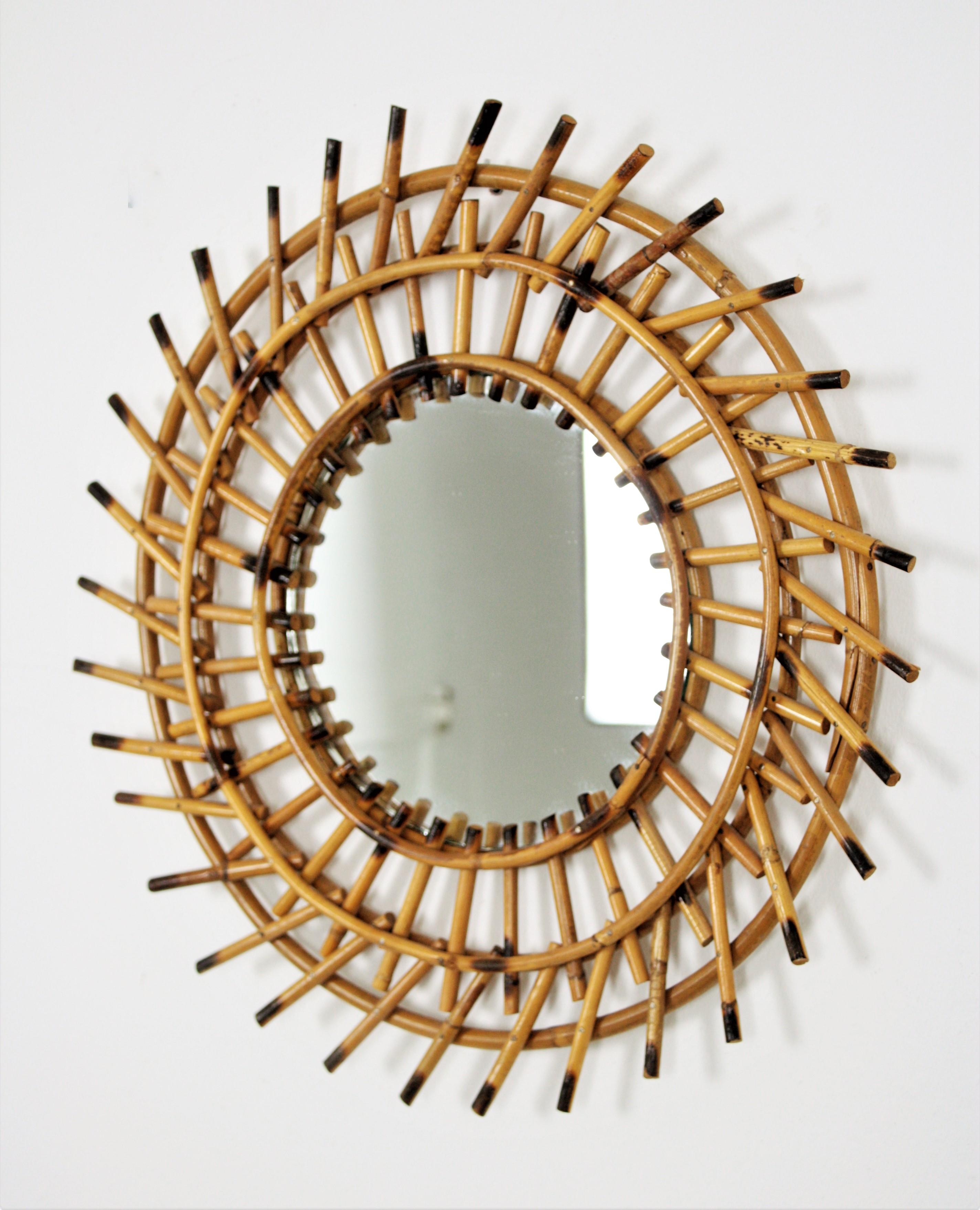 Rattan sunburst twisted mirror, France, 1960s.
Eye-catching double layered sunburst mirror with twisting accents on the frame.
This handcrafted mirror will be a nice addition to a beach house, countryside decoration or urban appartment. A cool