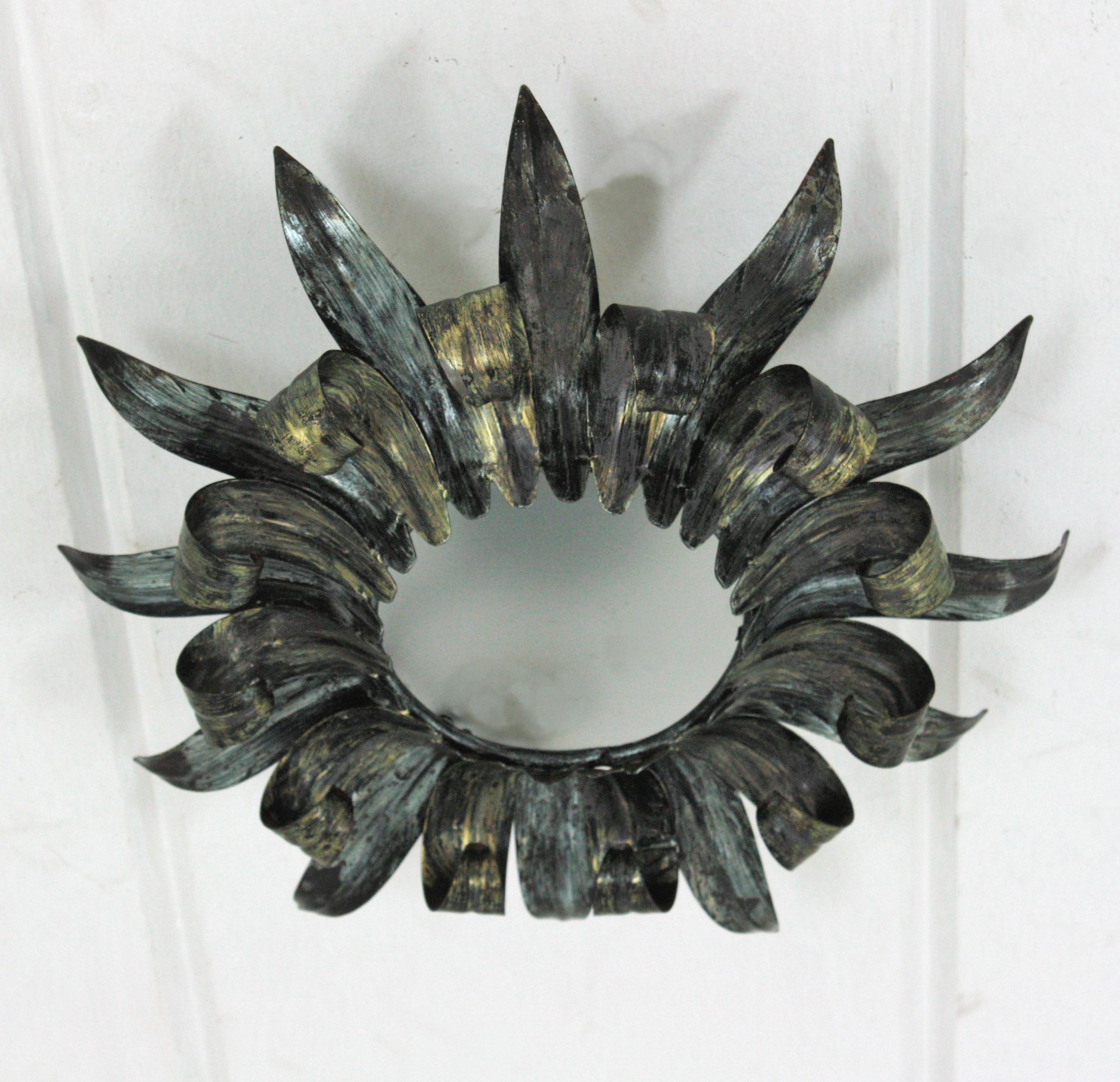 Brutalist patinated metal silvered sunburst light fixture, France, 1950s.
Eye-catching iron sunburst flush mount with frosted glass shade. It has alternating rays in eye-lash shape. Patinated in two-tone, silver color with golden accents. Nice aged