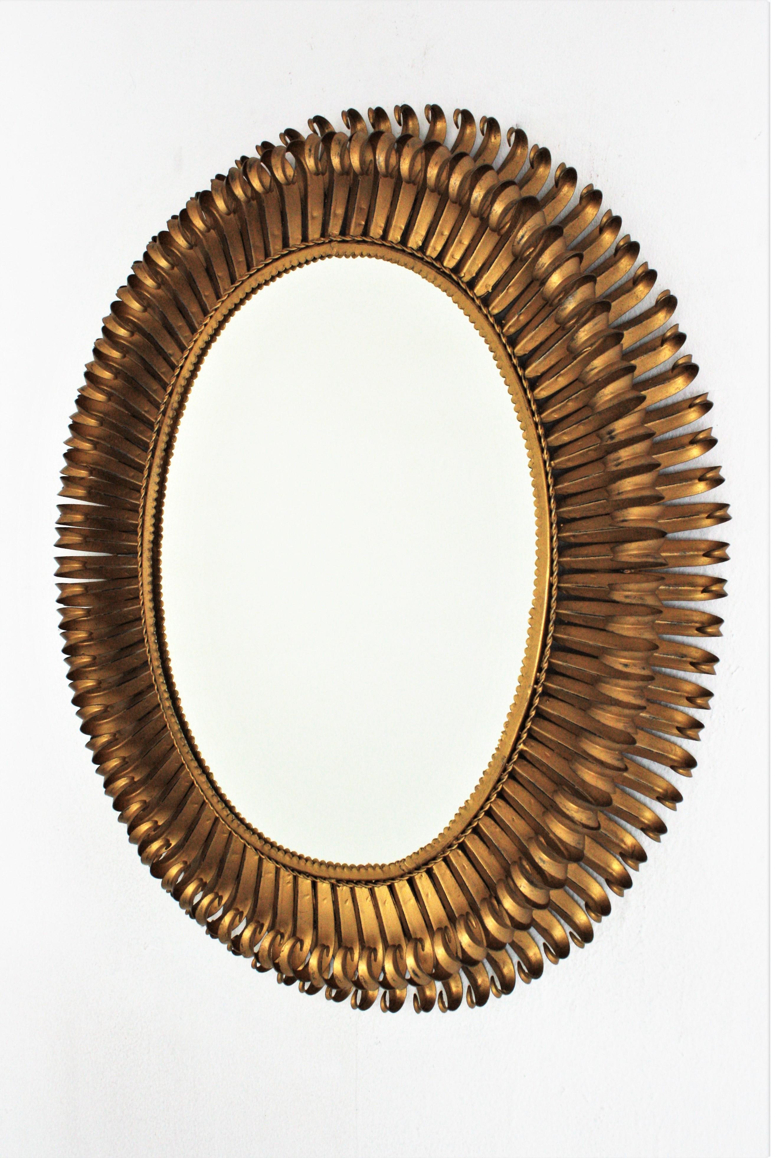 Hammered Sunburst Eyelash Large Oval Mirror in Gilt Wrought Iron For Sale