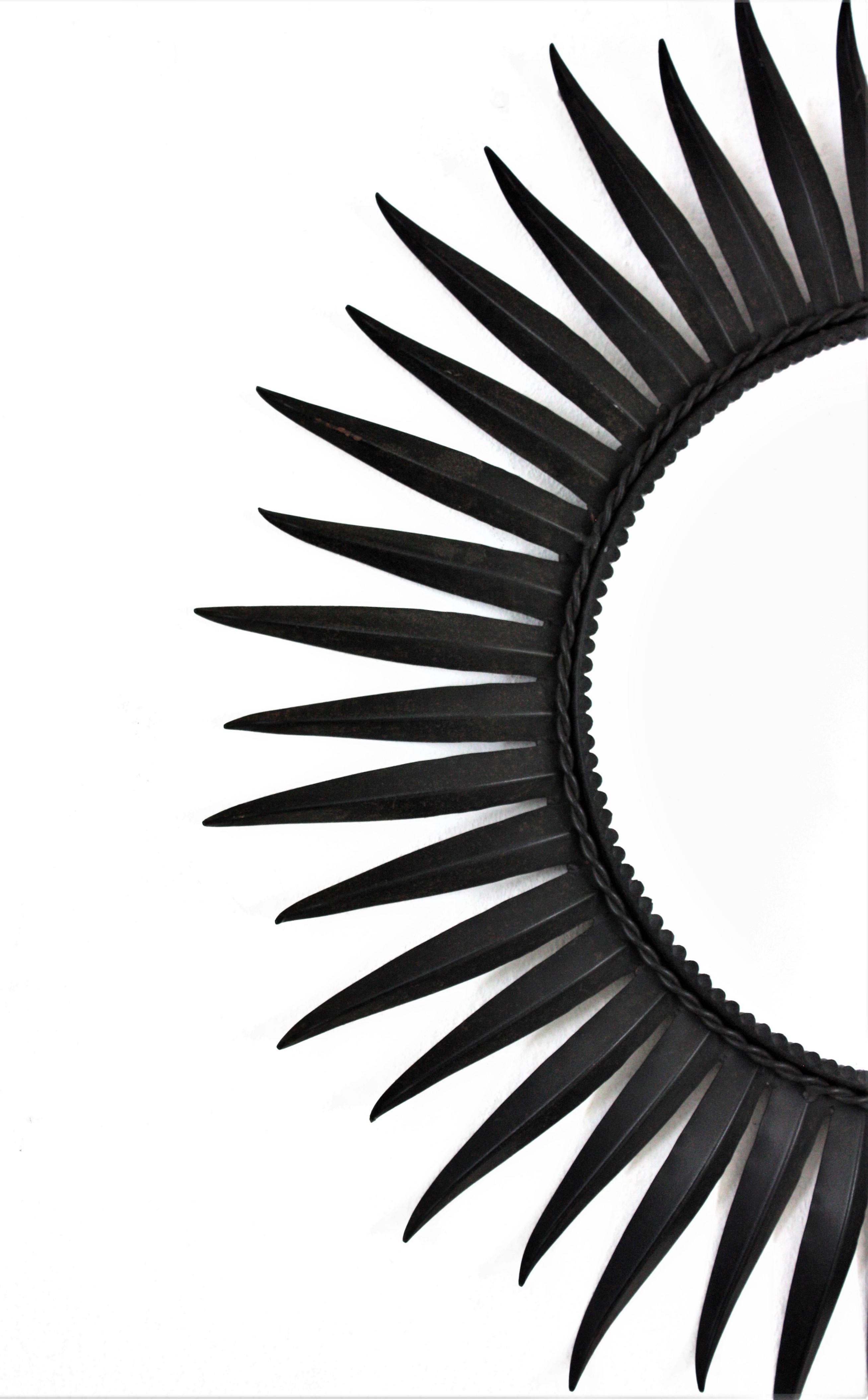 Gilt Sunburst Eyelash Mirror in Black Wrought Iron For Sale