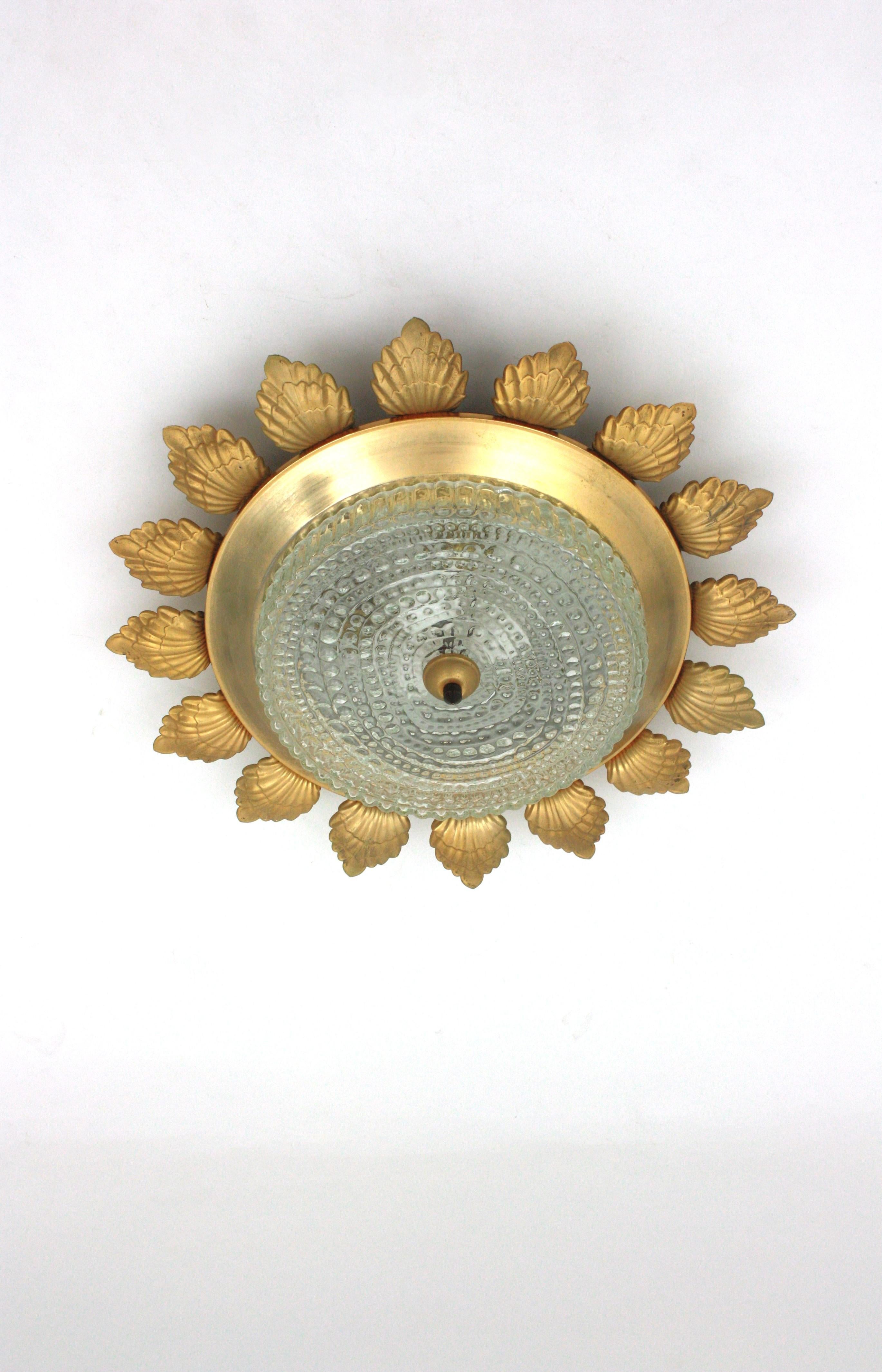 Mid-Century Modern Sunburst Flower Flush Mount Light Fixture in Gilt Metal and Pressed Glass For Sale