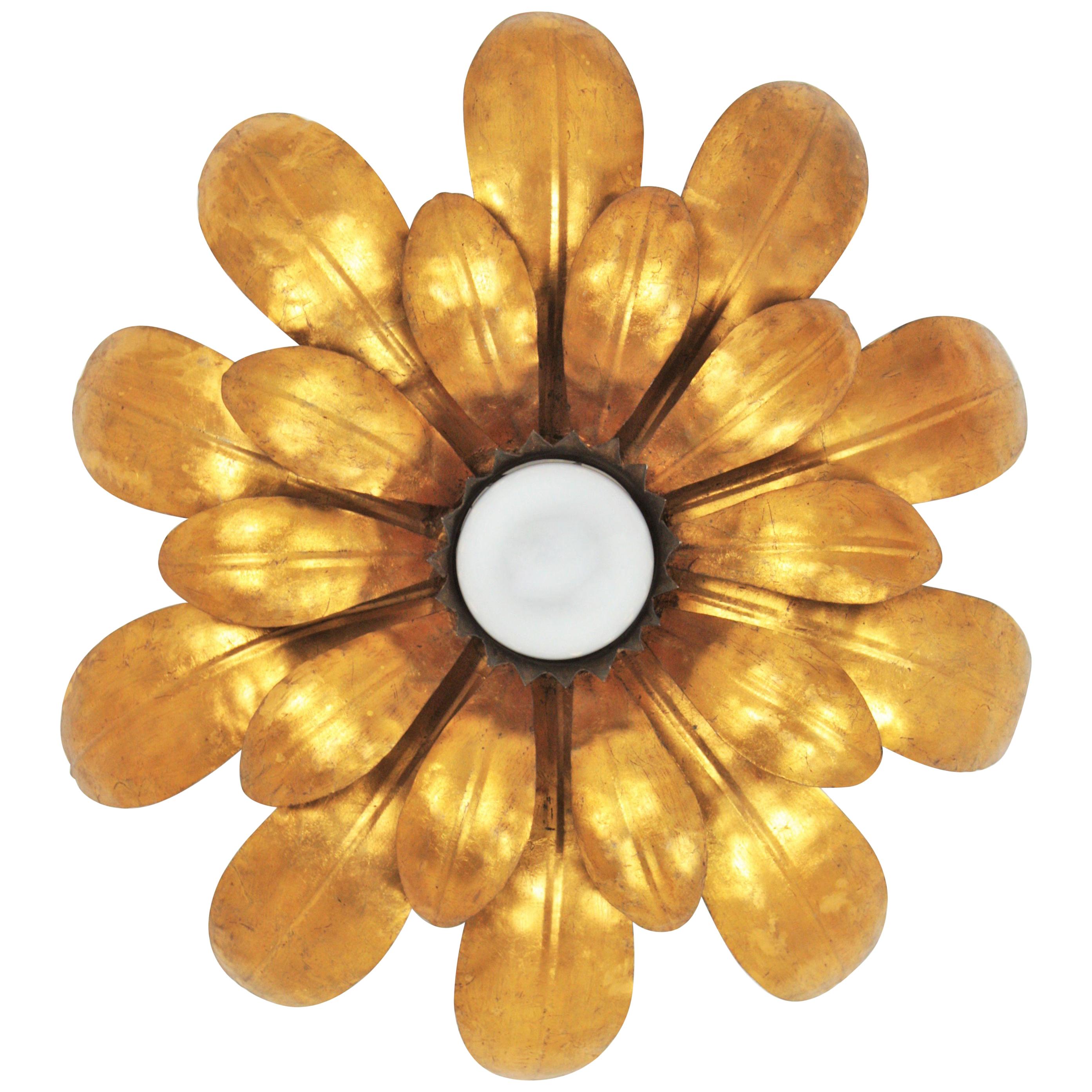 One of a kind Hollywood Regency double layered sunburst floral flushmount or light fixture, France, 1950
This sconce was finely executed, all made by hand and gilded with gold leaf.
It has a stylish design of leaves full of movement and a