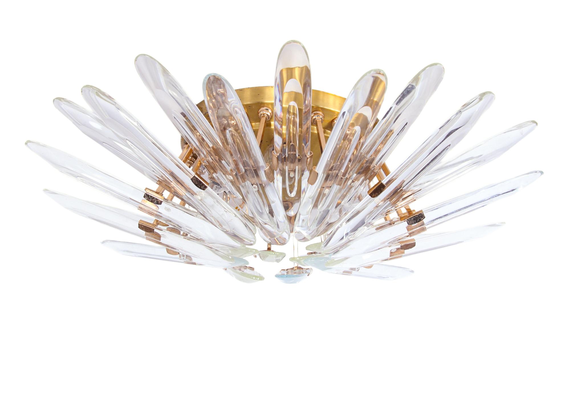 Elegant sunburst flush mount with 24 clear crystal glasses on a golden brass frame. Designed by Oscar Torlasco and manufactured by Stilkronen, Italy in the 1970s.

Manufacturer: Stilkronen.
Design: Oscar Torlasco.
Colours: clear and