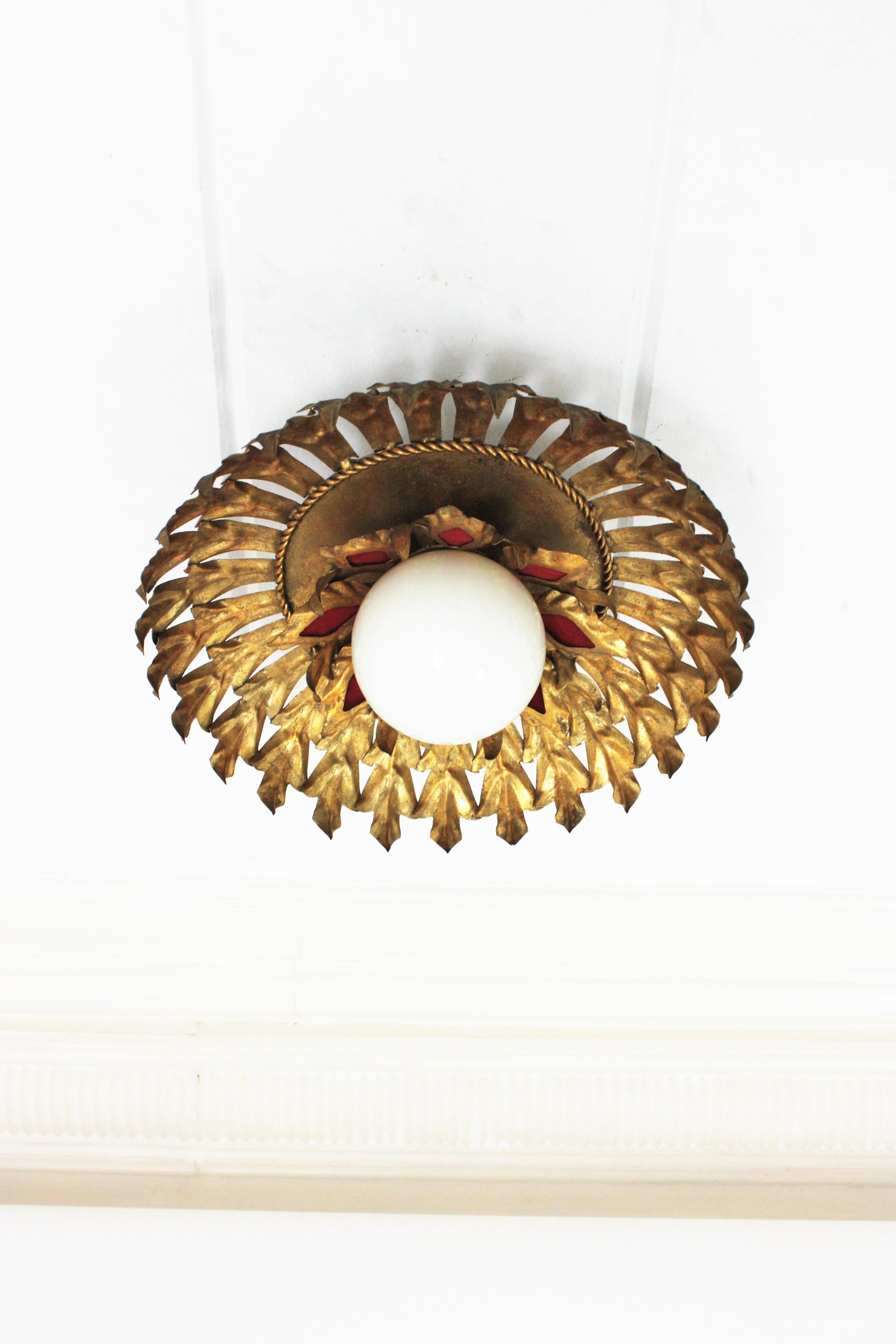 Hollywood Regency Sunburst Flush Mount Light Fixture in Gilt Iron and Milk Glass Globe For Sale