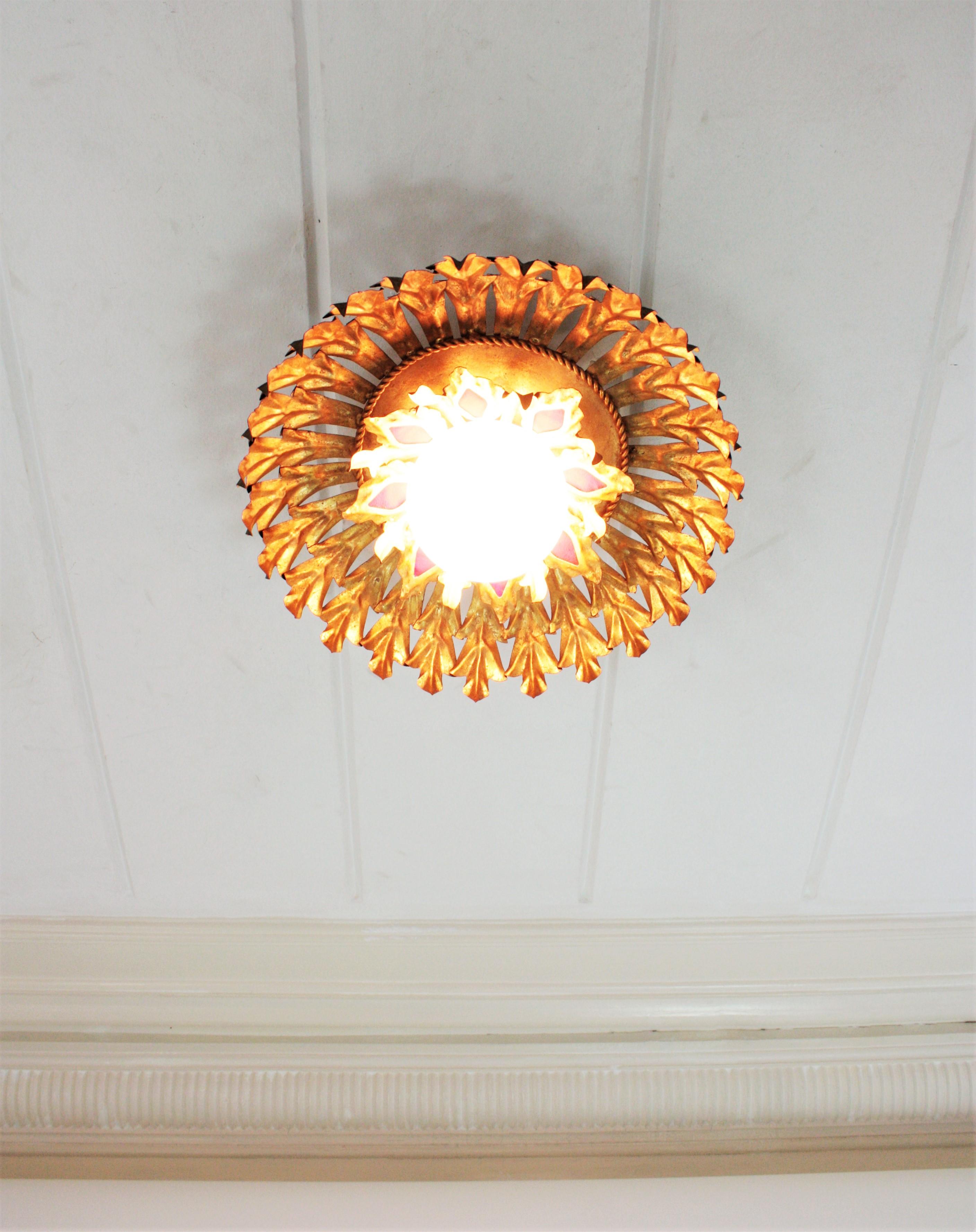 Spanish Sunburst Flush Mount Light Fixture in Gilt Iron and Milk Glass Globe For Sale