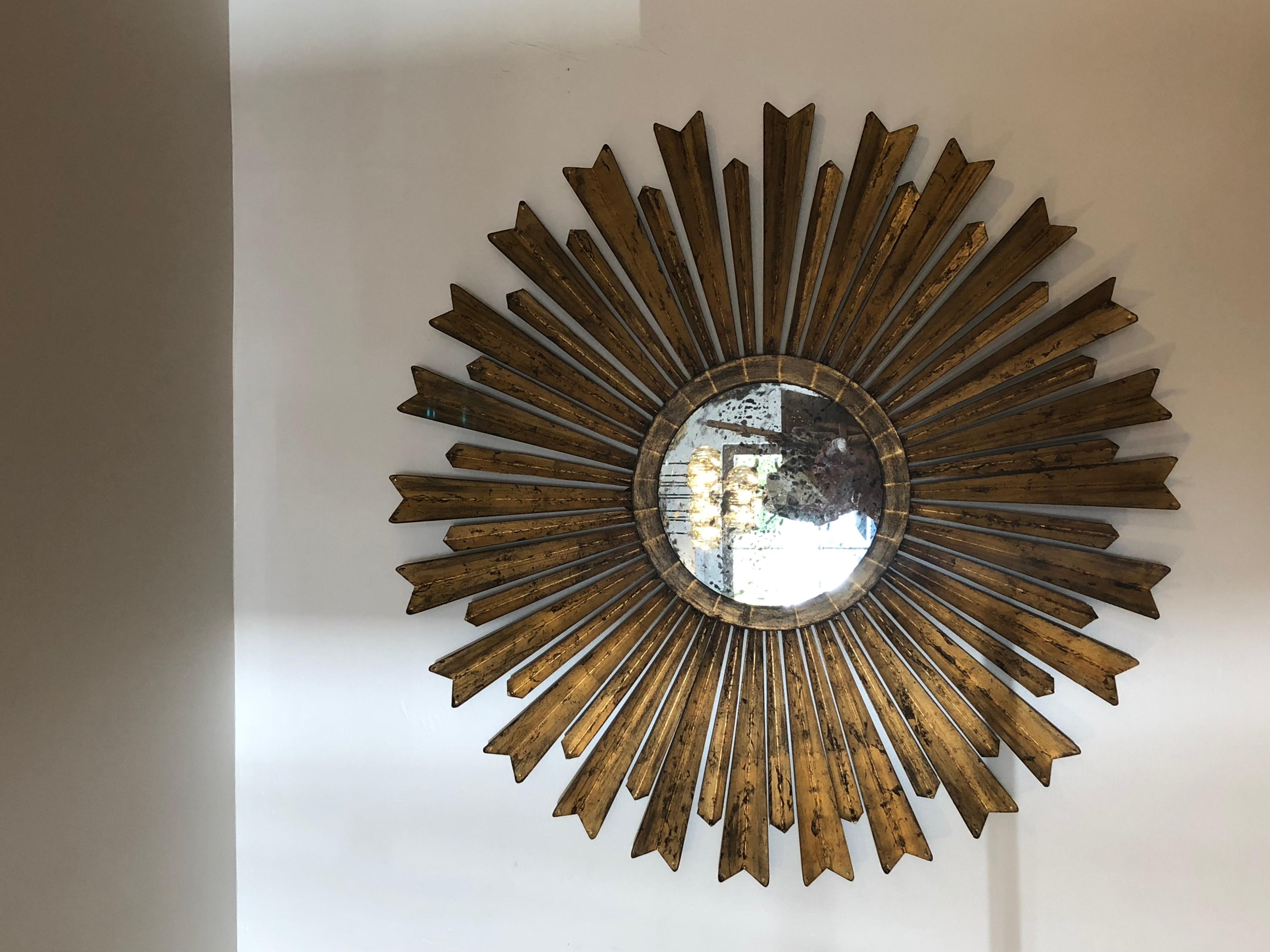 20th century gilt sunburst mirror with patina galore! This beauty has generous proportions measuring 34