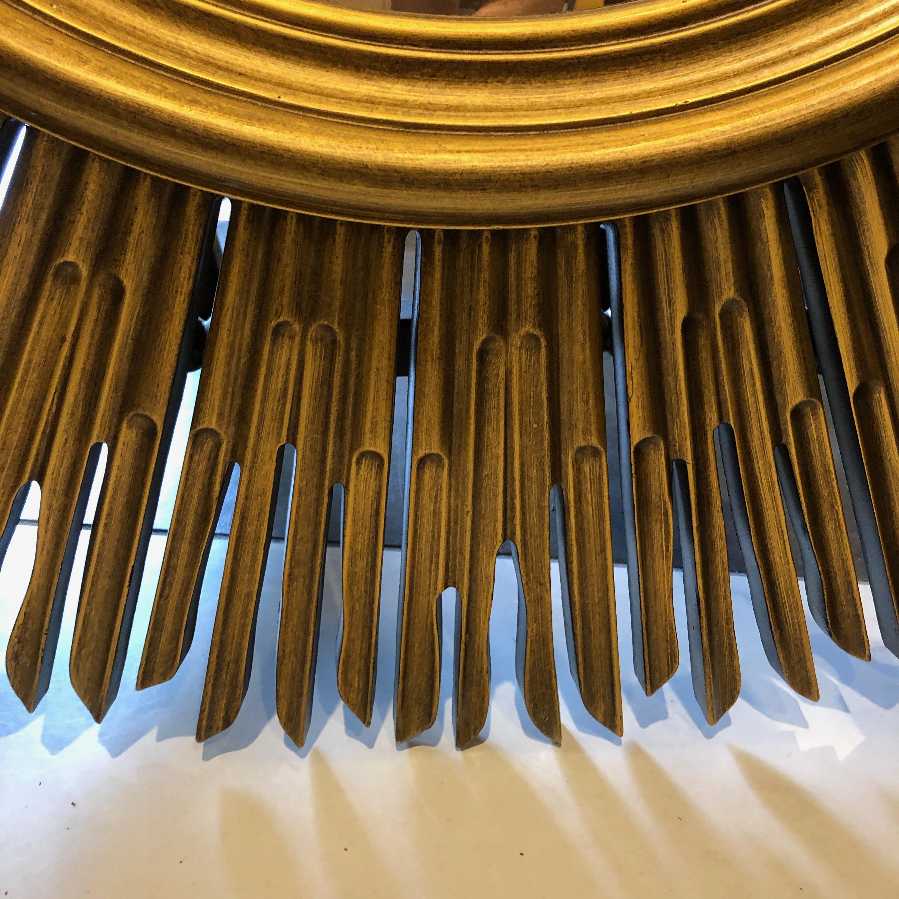 Large sunburst mirror finished in gold well made by Baker.