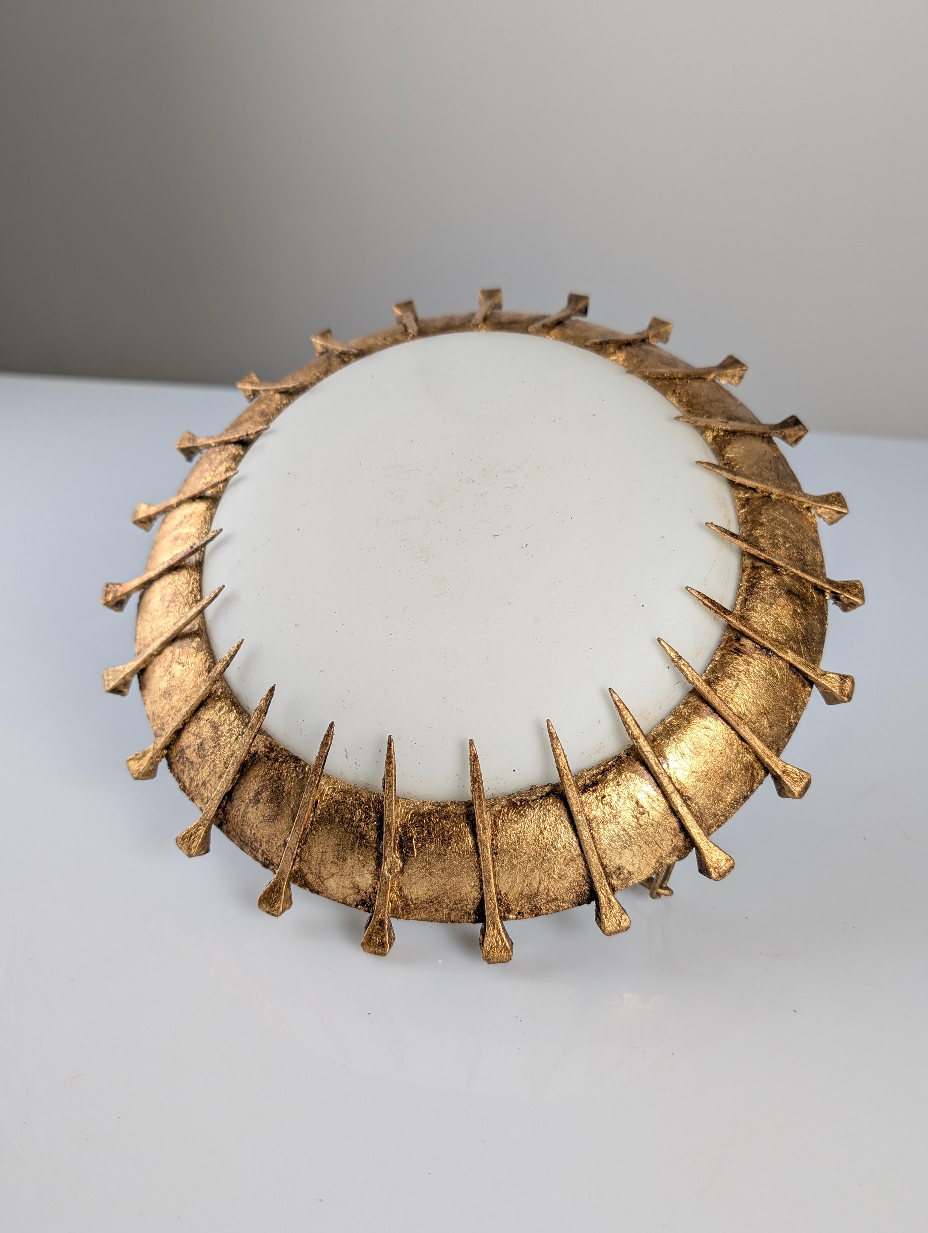 French hanging lamp from the 1940s with a fantastic sun design that conveys elegance and character to any room thanks to the formidable craftsmanship of perfectly placed forged nails treated with gold leaf.