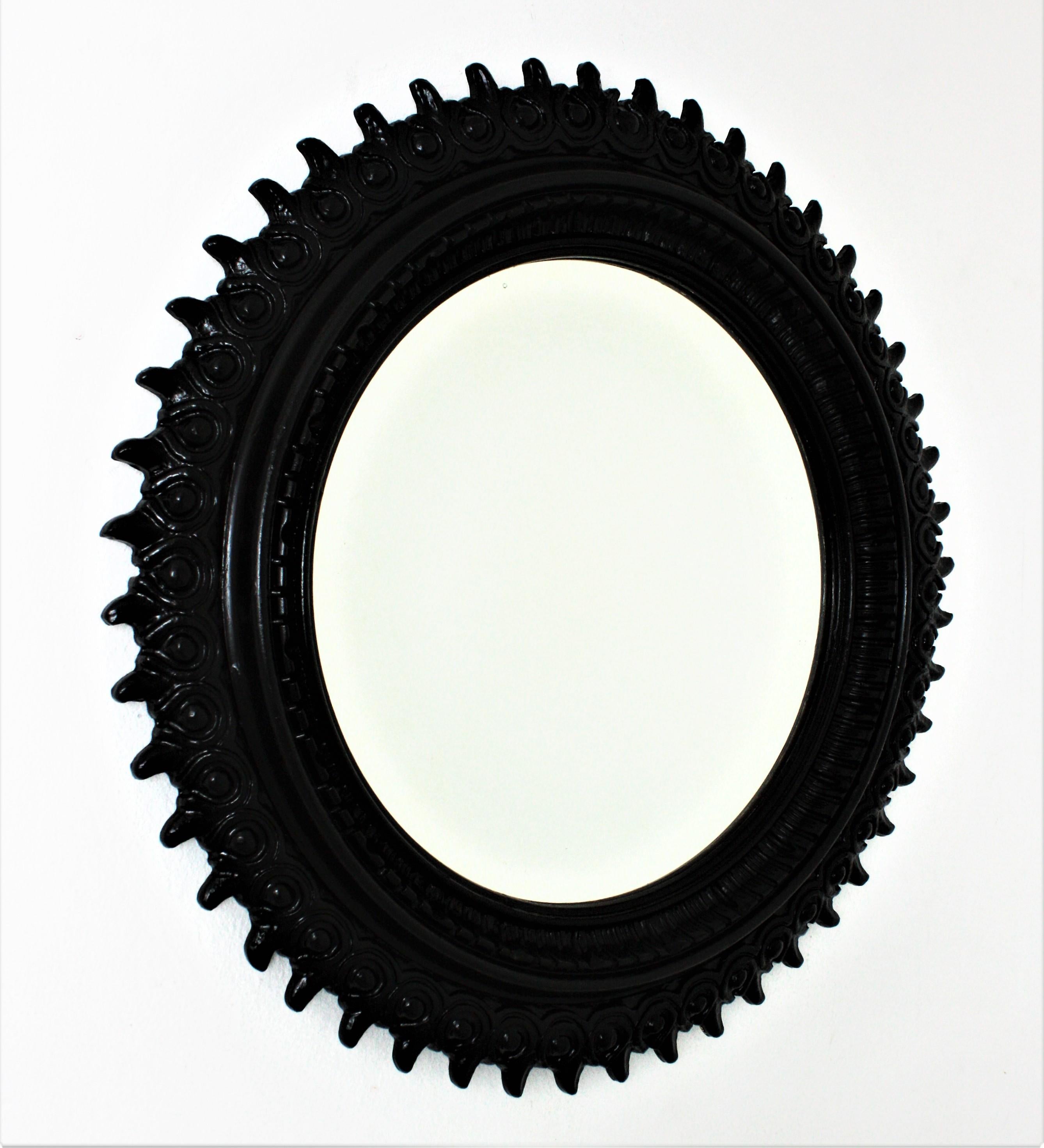 Mid-Century Modern Sunburst Mirror in Carved Wood and Black Patina by Francisco Hurtado For Sale