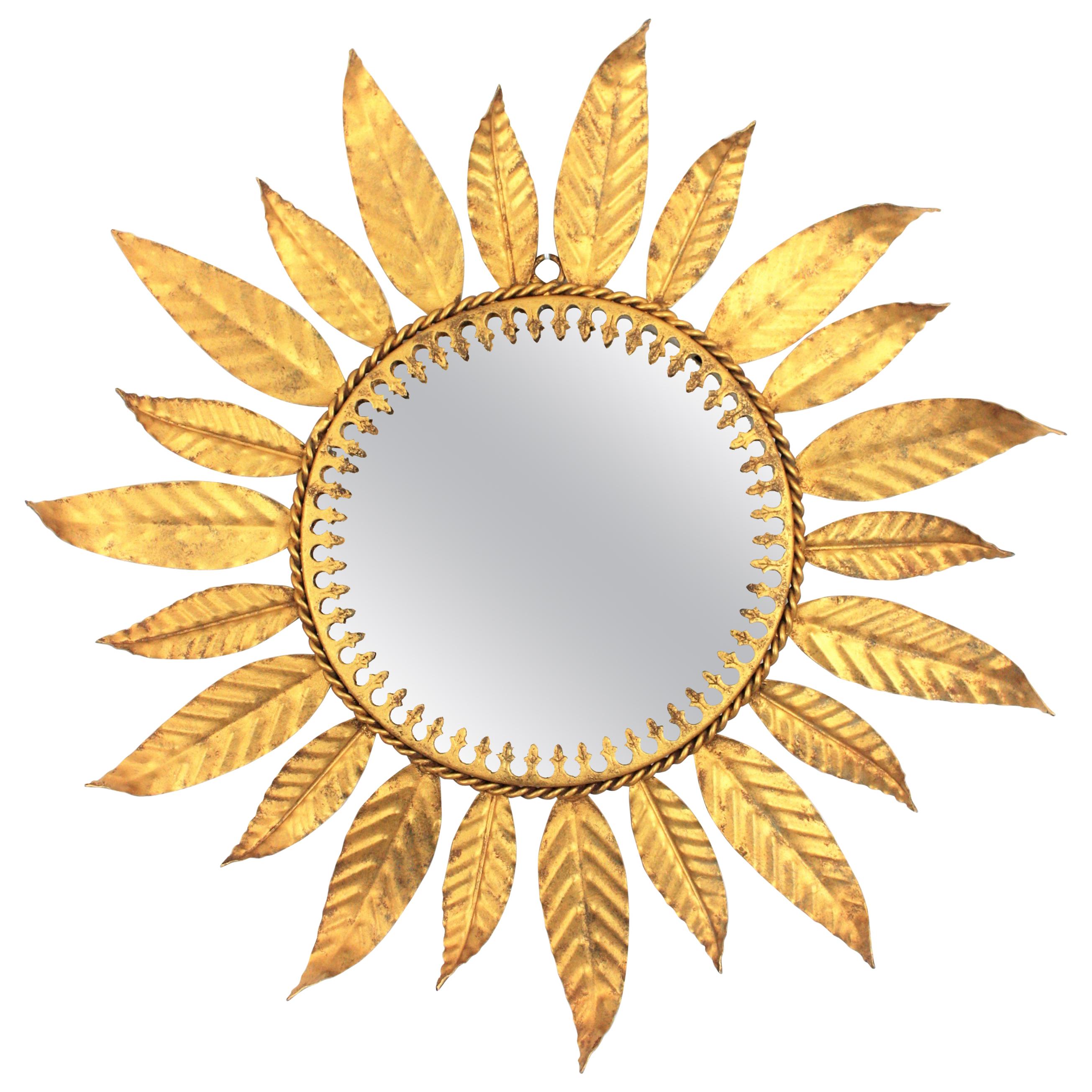 Eye-catching midcentury gilt iron sunburst mirror framed by Laurel leaves. Spain, 1960s.
Beautiful placed alone or as a part of a wall composition with other mirrors in the manner as we show at the images
Overall measures: 45 cm diameter x 2.5 cm