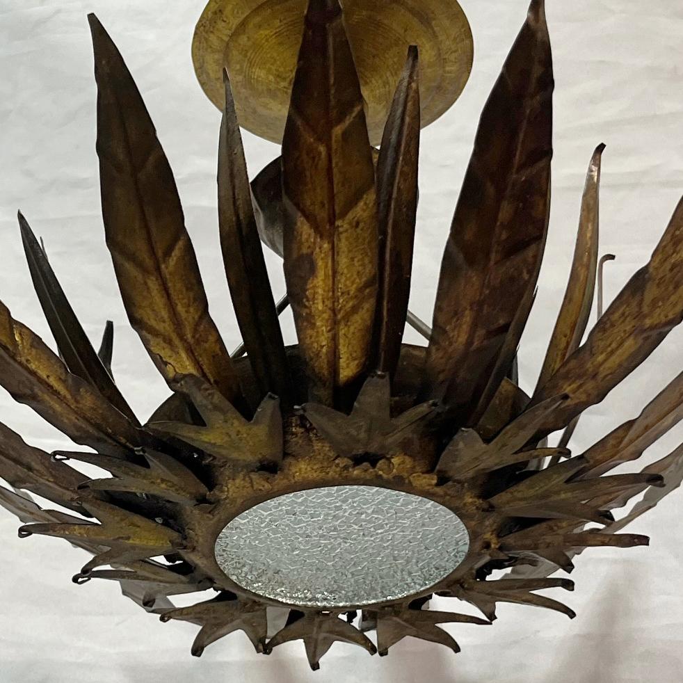 A circa 1950's Italian hammered sunburst light fixture with one interior light.

Measurements:
Diameter: 14
Height:10