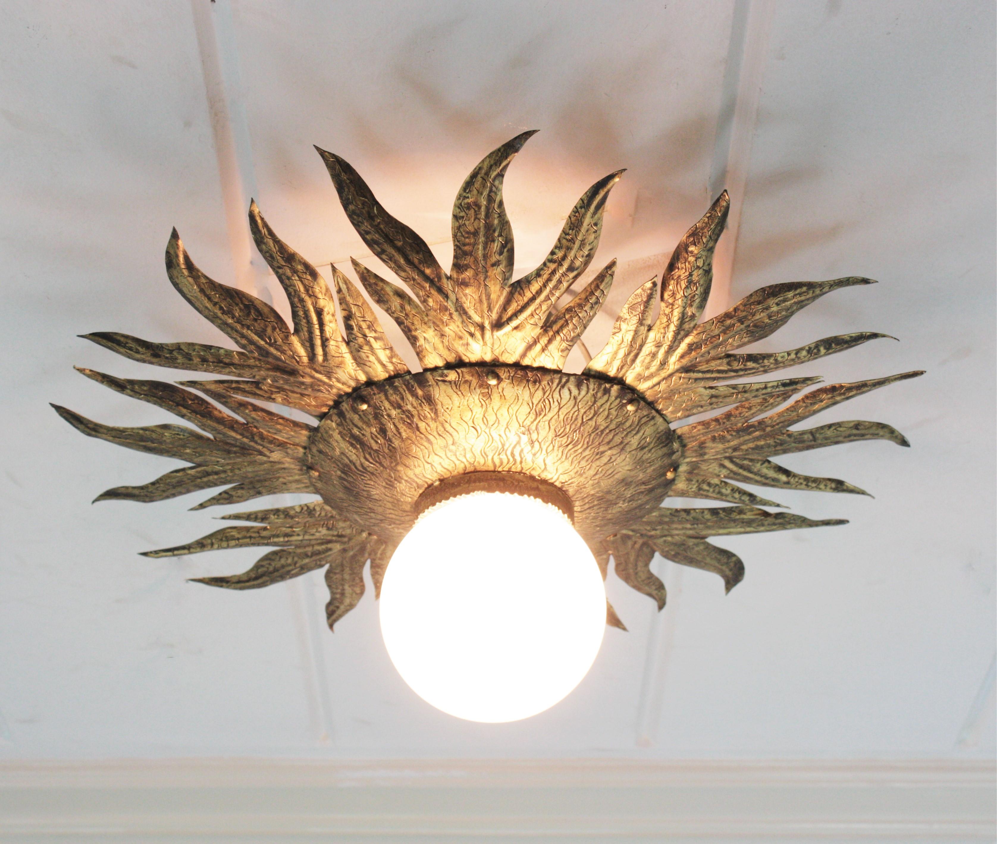 Spanish Sunburst Light Fixture in Gilt Metal and Milk Glass For Sale