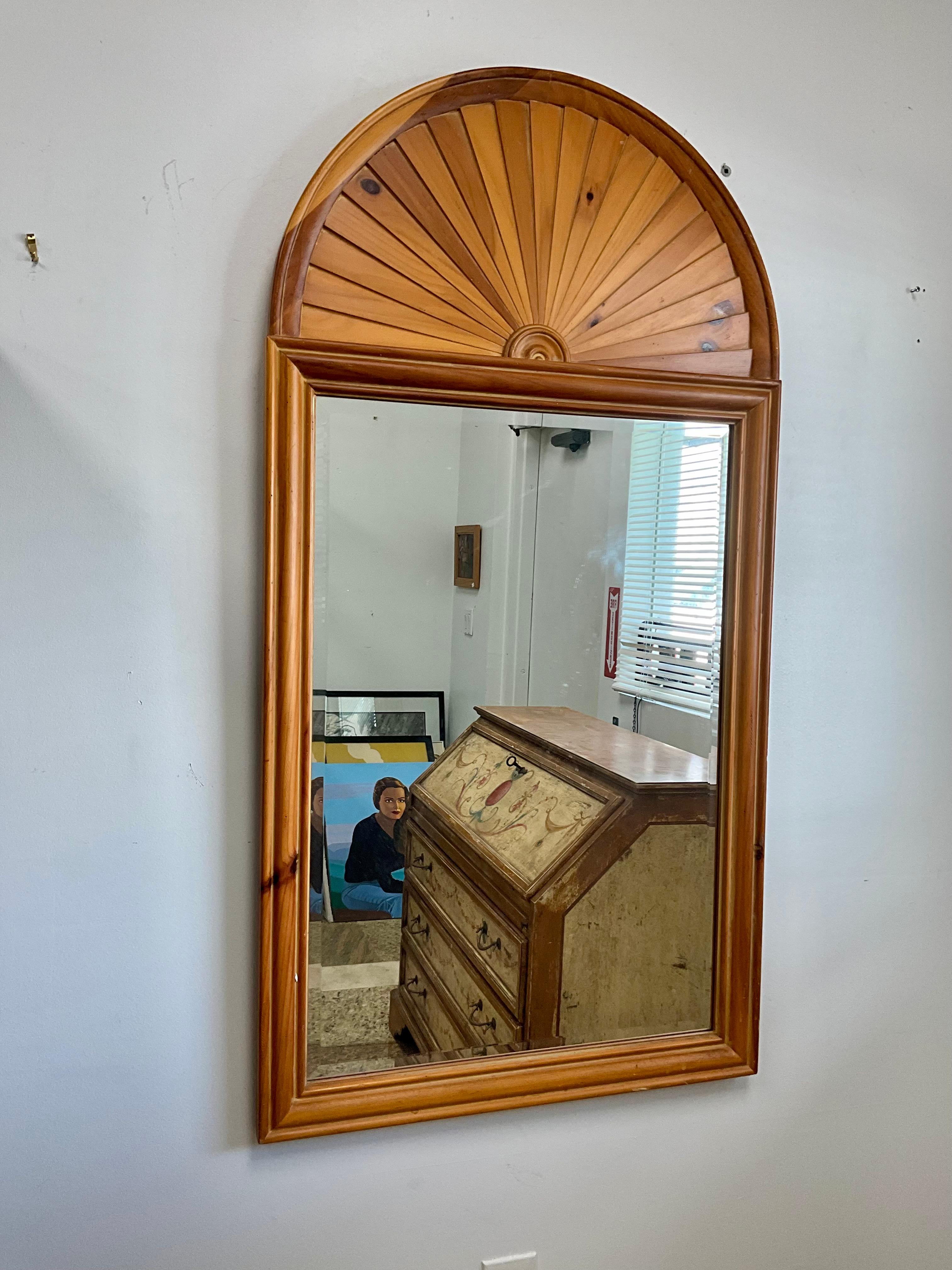 Vintage Knotty Pine Rectangular Mirror with Arched Sunburst Top in the Style of John Dickinson

This vintage knotty pine rectangular mirror features an elegant arched sunburst top, inspired by John Dickinson's iconic 1980s designs. The warm tones of