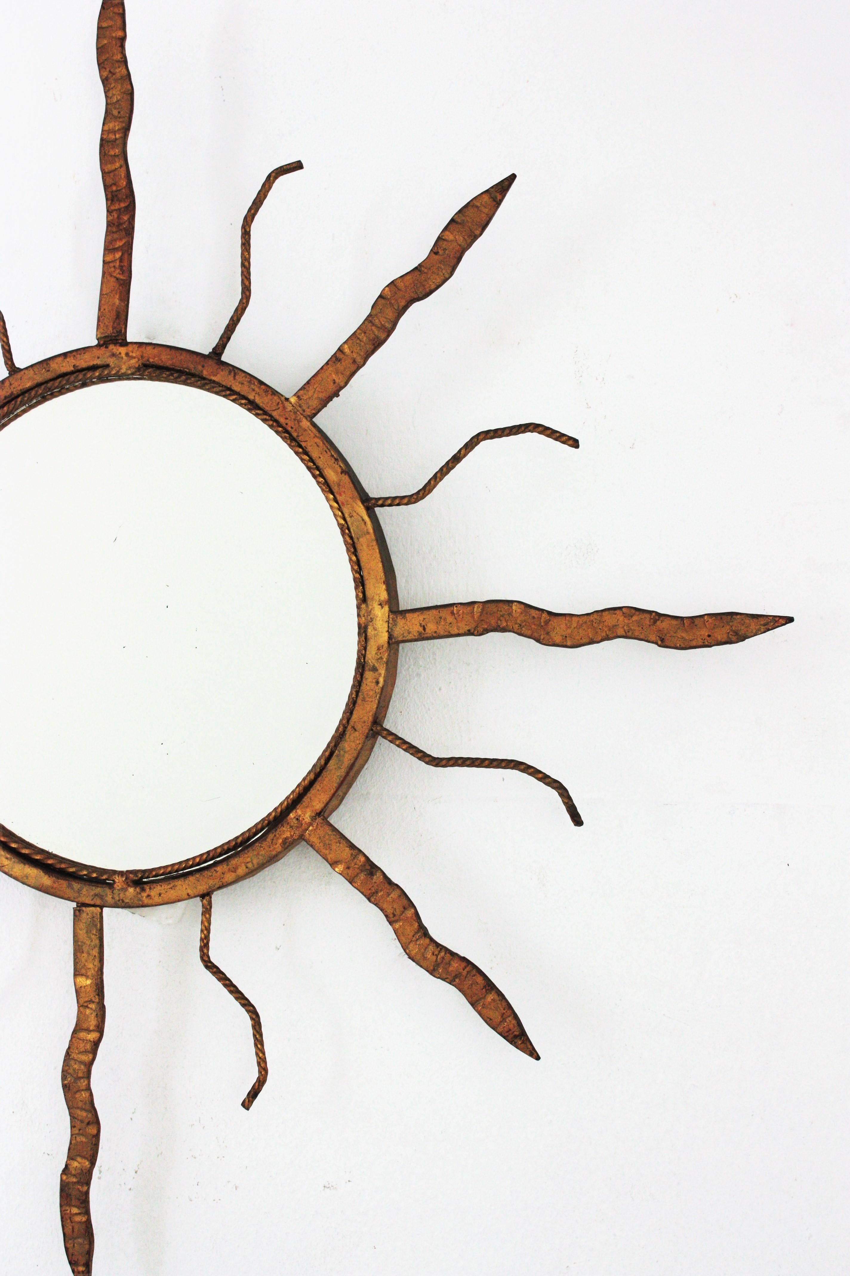 French Sunburst Mirror in Gilt Iron in the Style of Poillerat