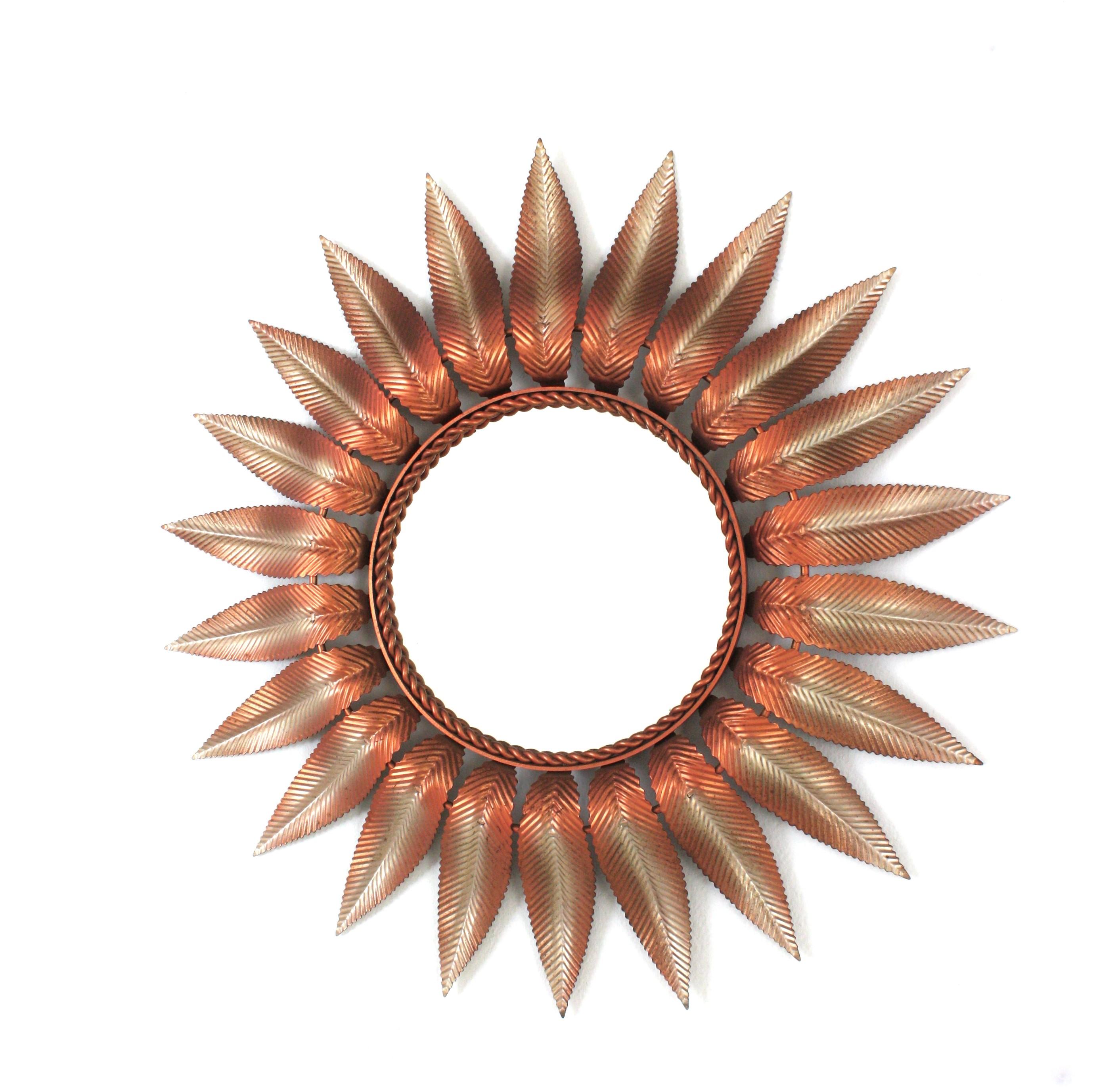 Mid-Century Modern Sunburst Flower Wall Mirror with pink and silver metal frame. Spain, 1960s.
This wall mirror features a layers of pinkish leaves with gilt silver accents surrounding a central glass.
Unique piece in these colors.
Very good vintage