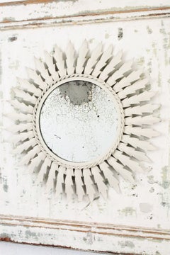 Sunburst Mirror in White Metal Framed by a Wood Patinated Door