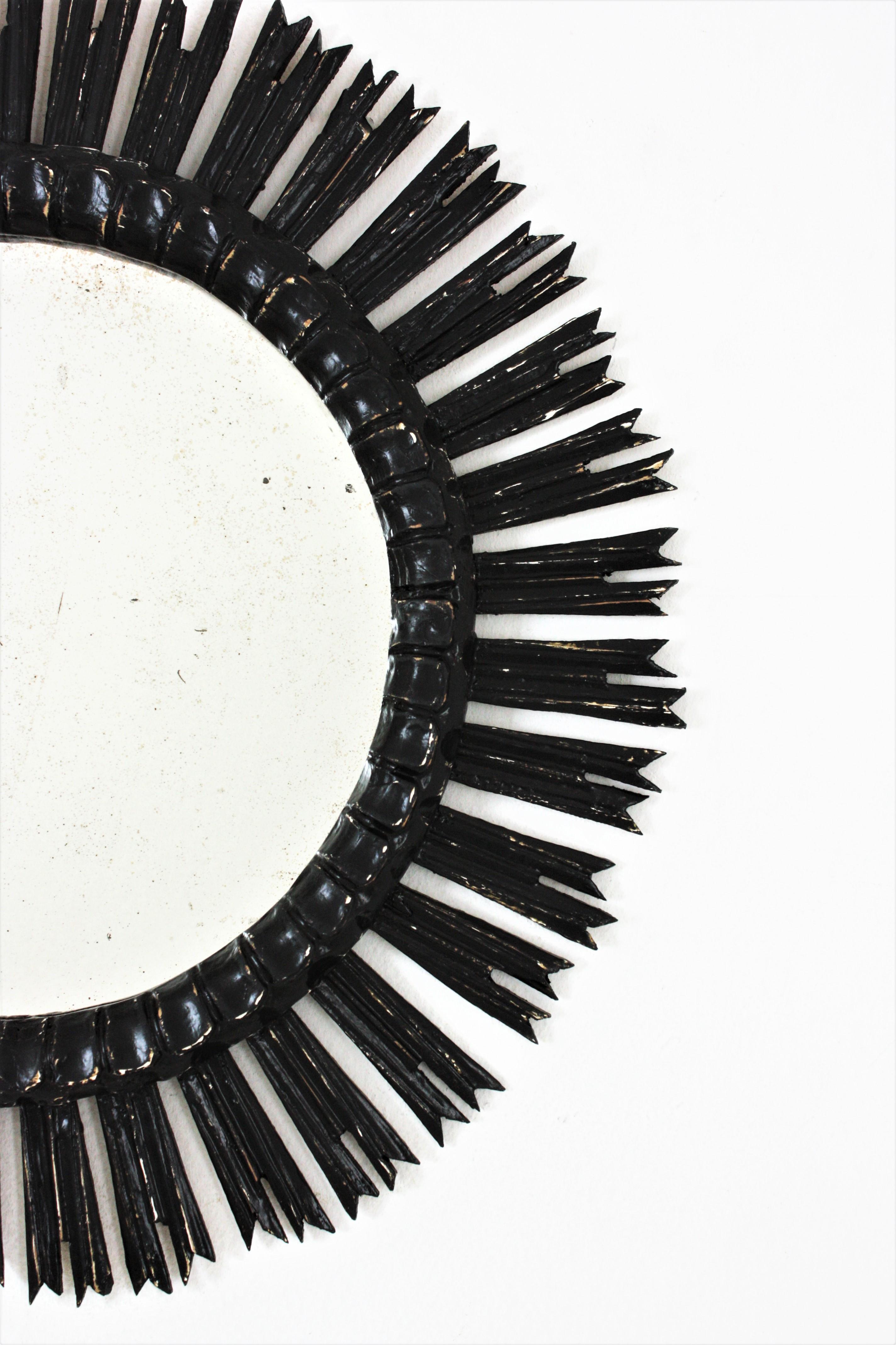 Carved Sunburst Mirror in Wood Black Patina, Spain, 1940s For Sale