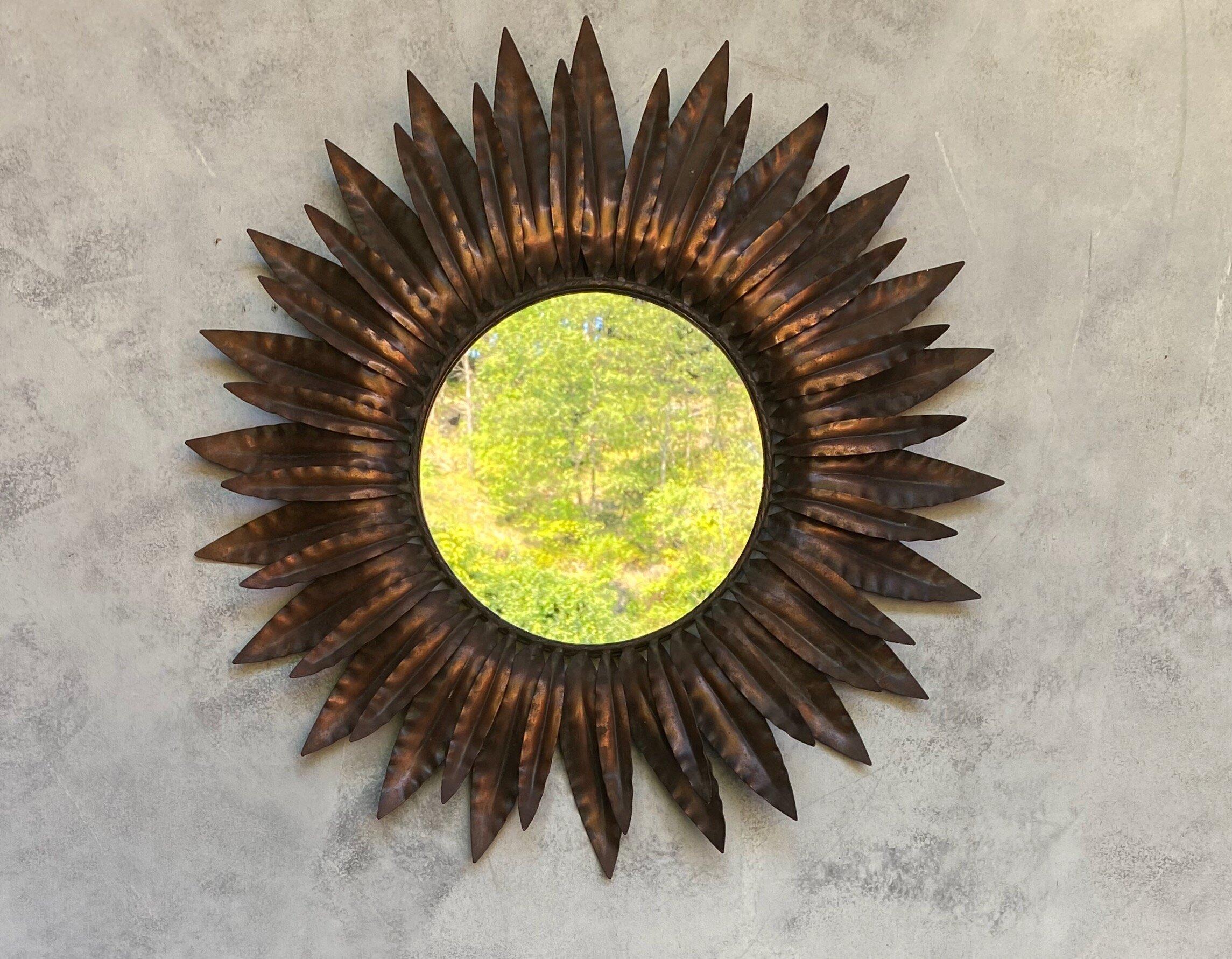 This unusual sunburst mirror captures the beauty and charm of the Spanish countryside. The mirror boasts a unique double layer of radiating leaves, each with its own rich copper plated patina, giving it a distinctive look that's sure to catch the