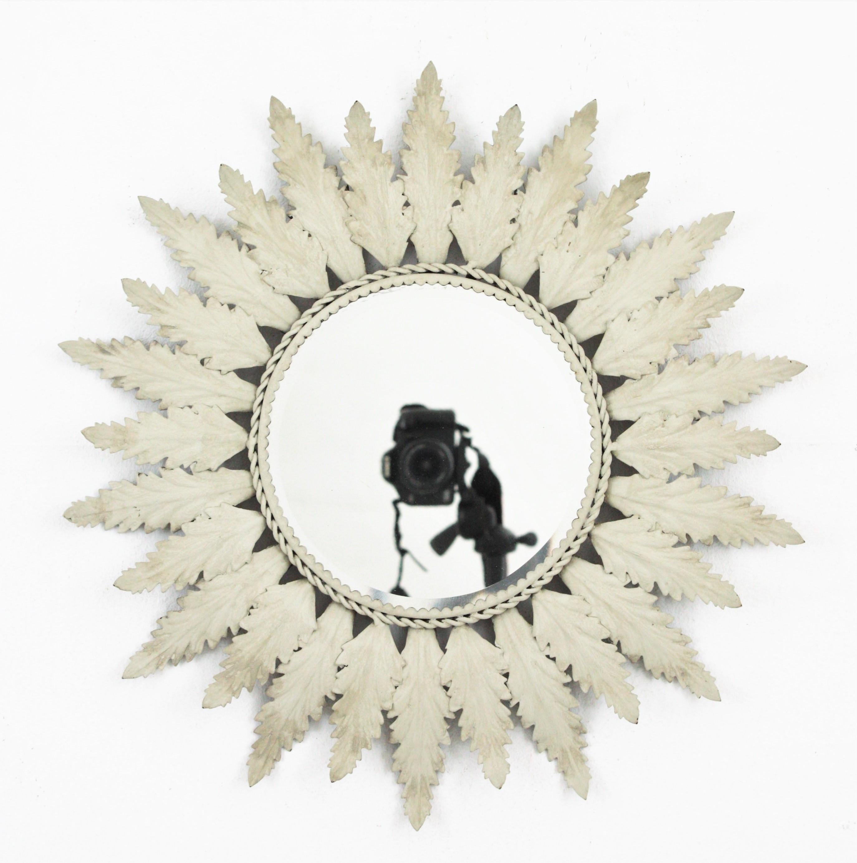Eye-catching metal sunburst or flower shaped mirror with white-grey matte patina, Spain, 1960s
This lovely sunburst has alternating leaves in two sizes surrounding a central round beveled glass. This mirror will be a nice addition in a country