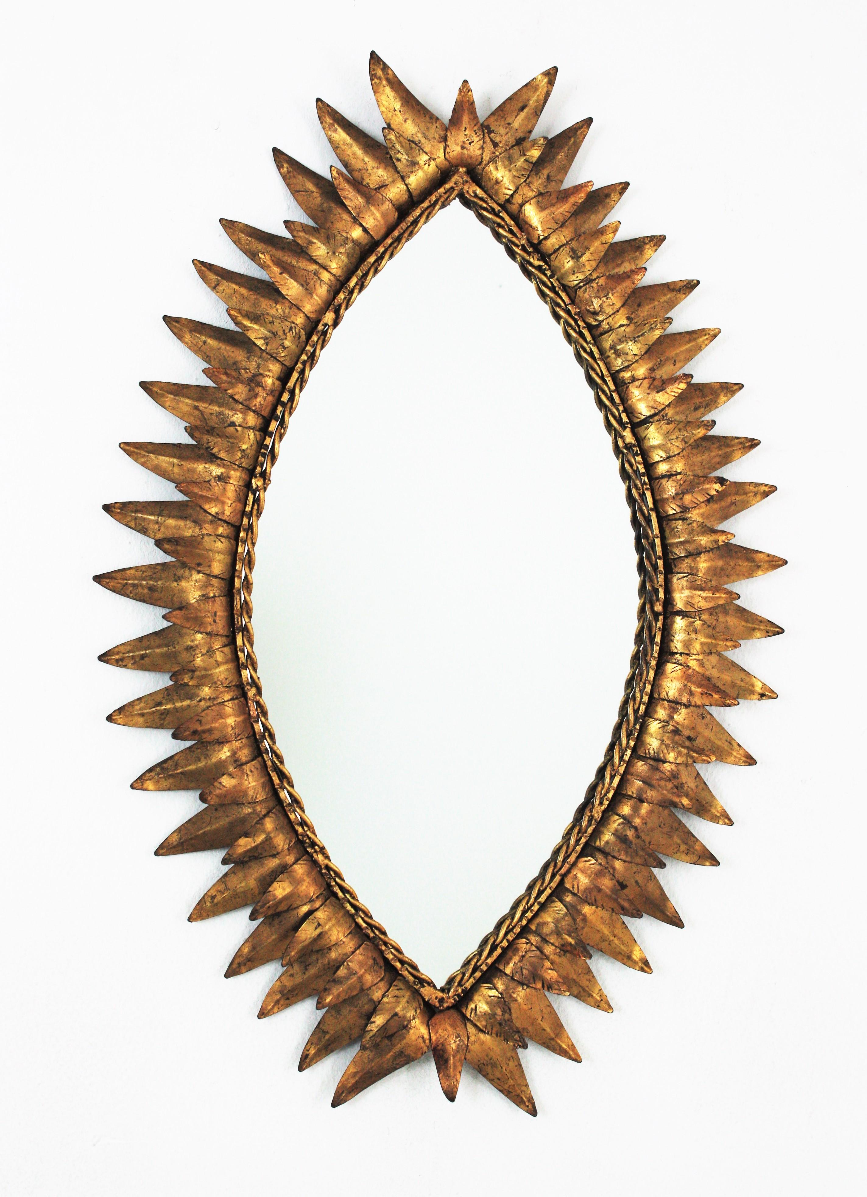 Ovaler Spiegel in Augenform mit Sonnenschliff aus vergoldetem Eisen (Hollywood Regency) im Angebot