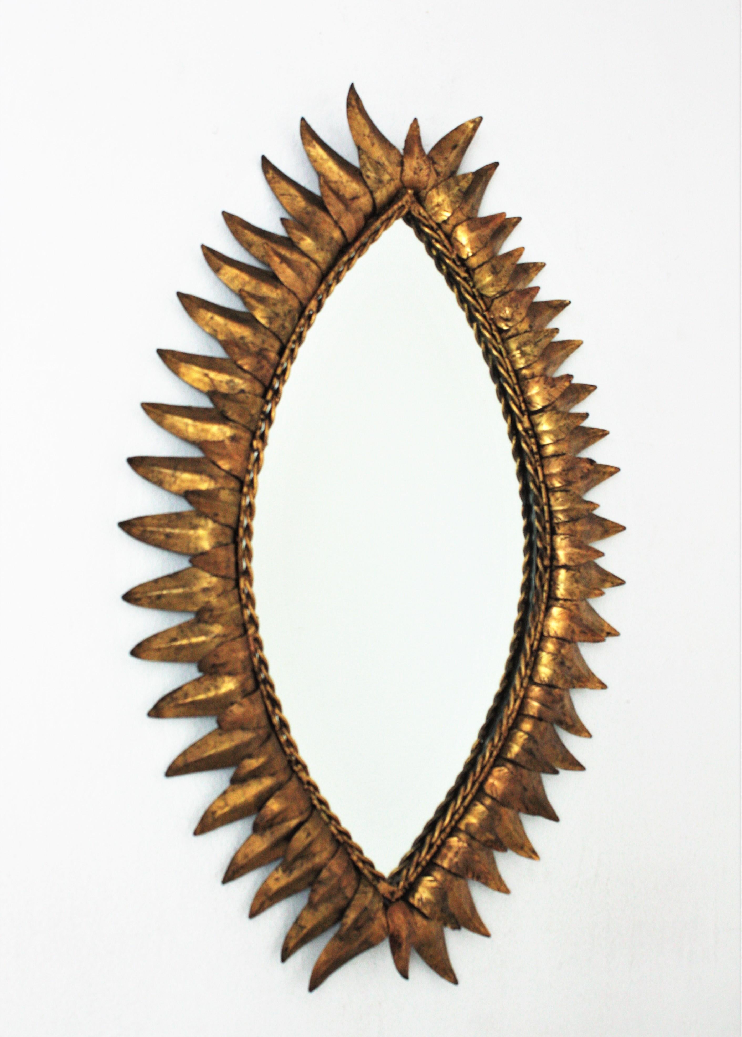 Hollywood Regency Sunburst Oval Eye Shaped Mirror in Gilt Iron For Sale
