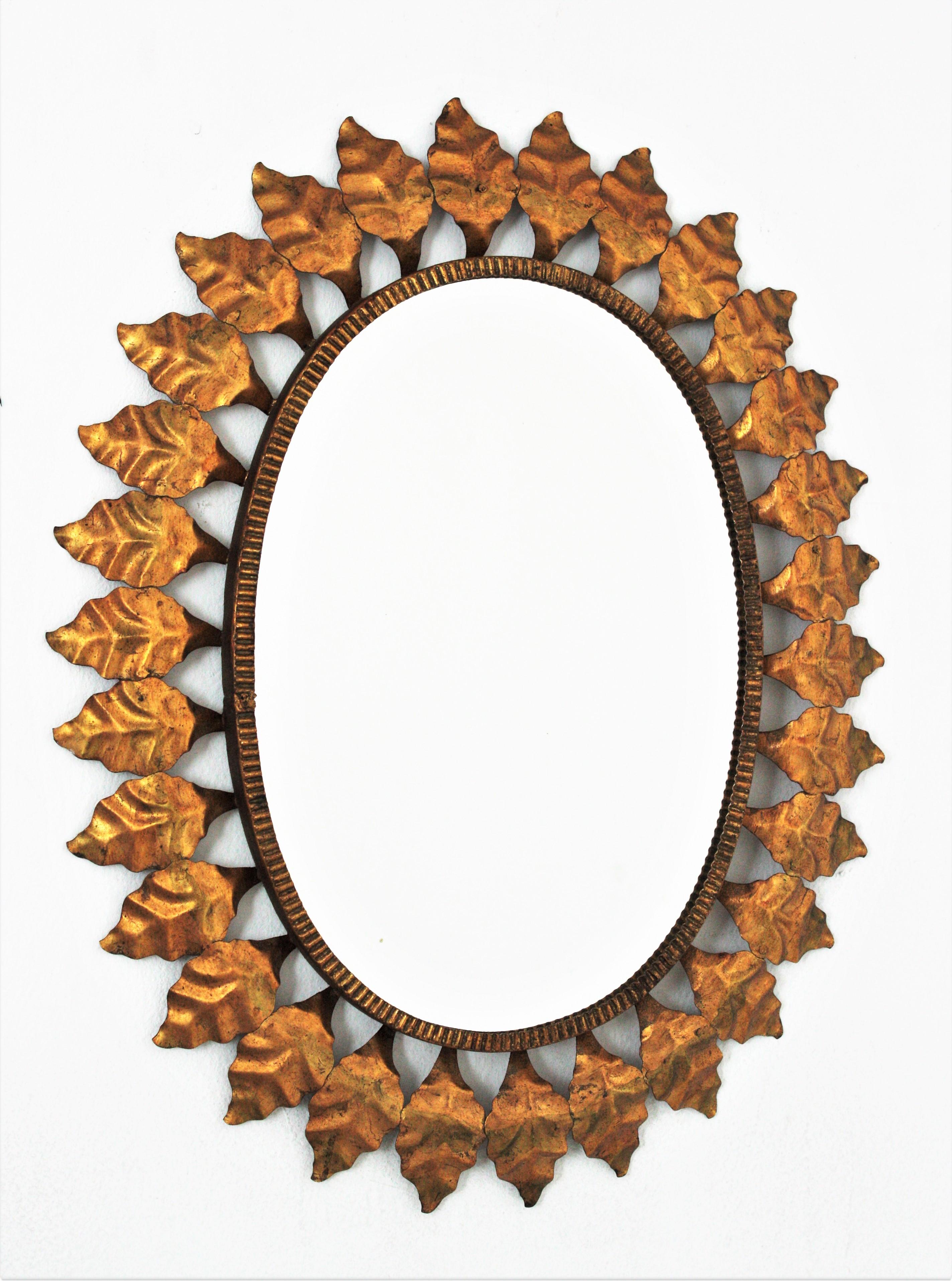 Hollywood Regency Sunburst Oval Mirror in Gilt Iron