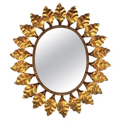 Miroir ovale en métal doré, années 1950