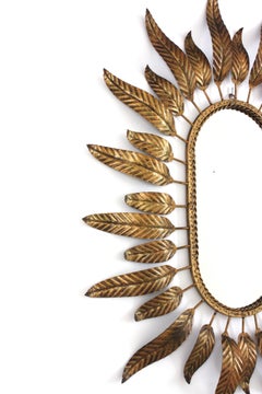 Miroir ovale Sunburst en métal doré avec cadre à feuillage