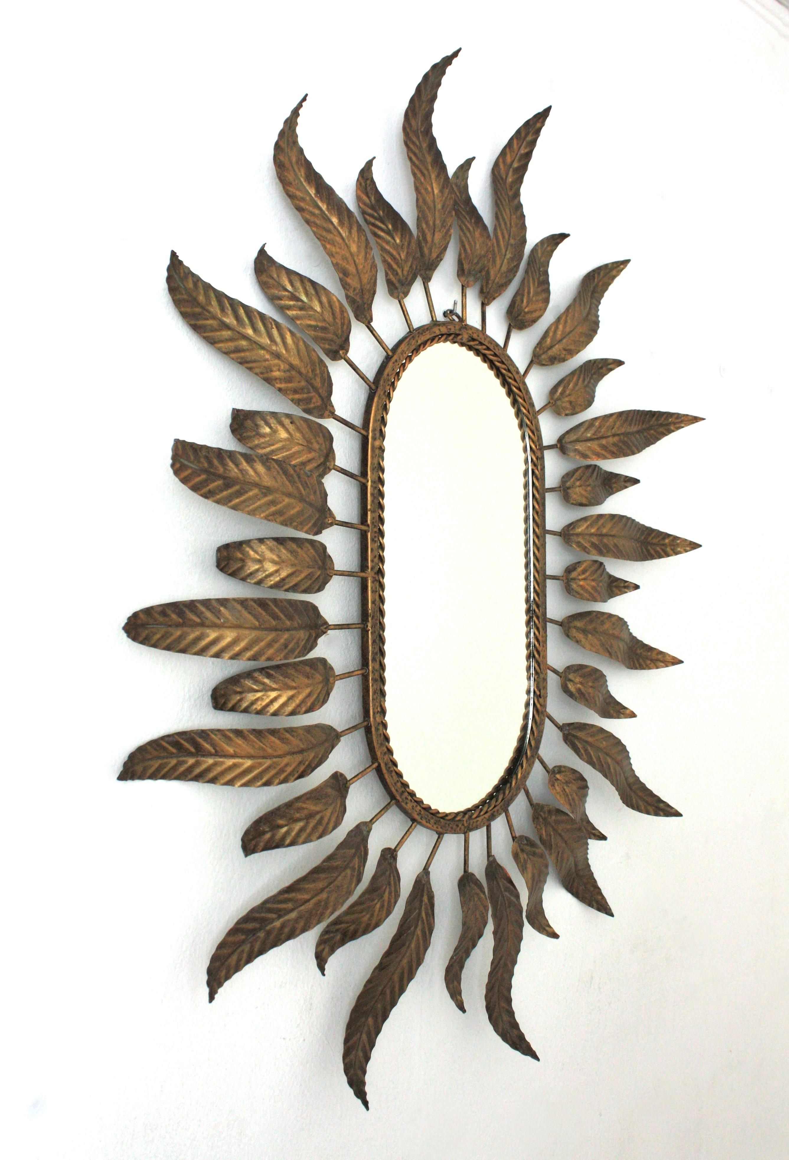 Mid-Century Modern Sunburst Oval Mirror in Gilt Metal with Foliage Frame For Sale