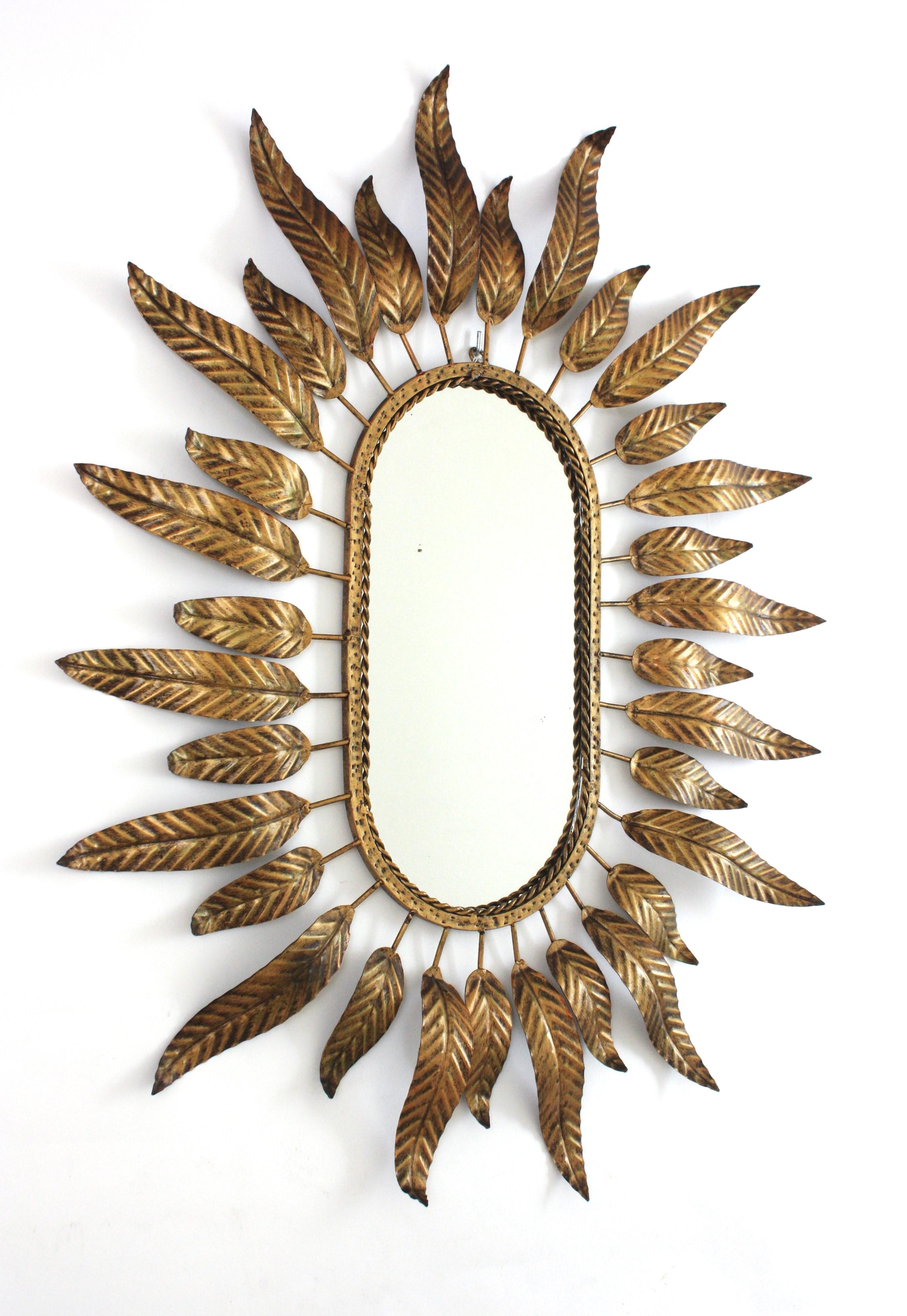 Spagnolo Specchio ovale Sunburst in metallo dorato con cornice fogliacea in vendita