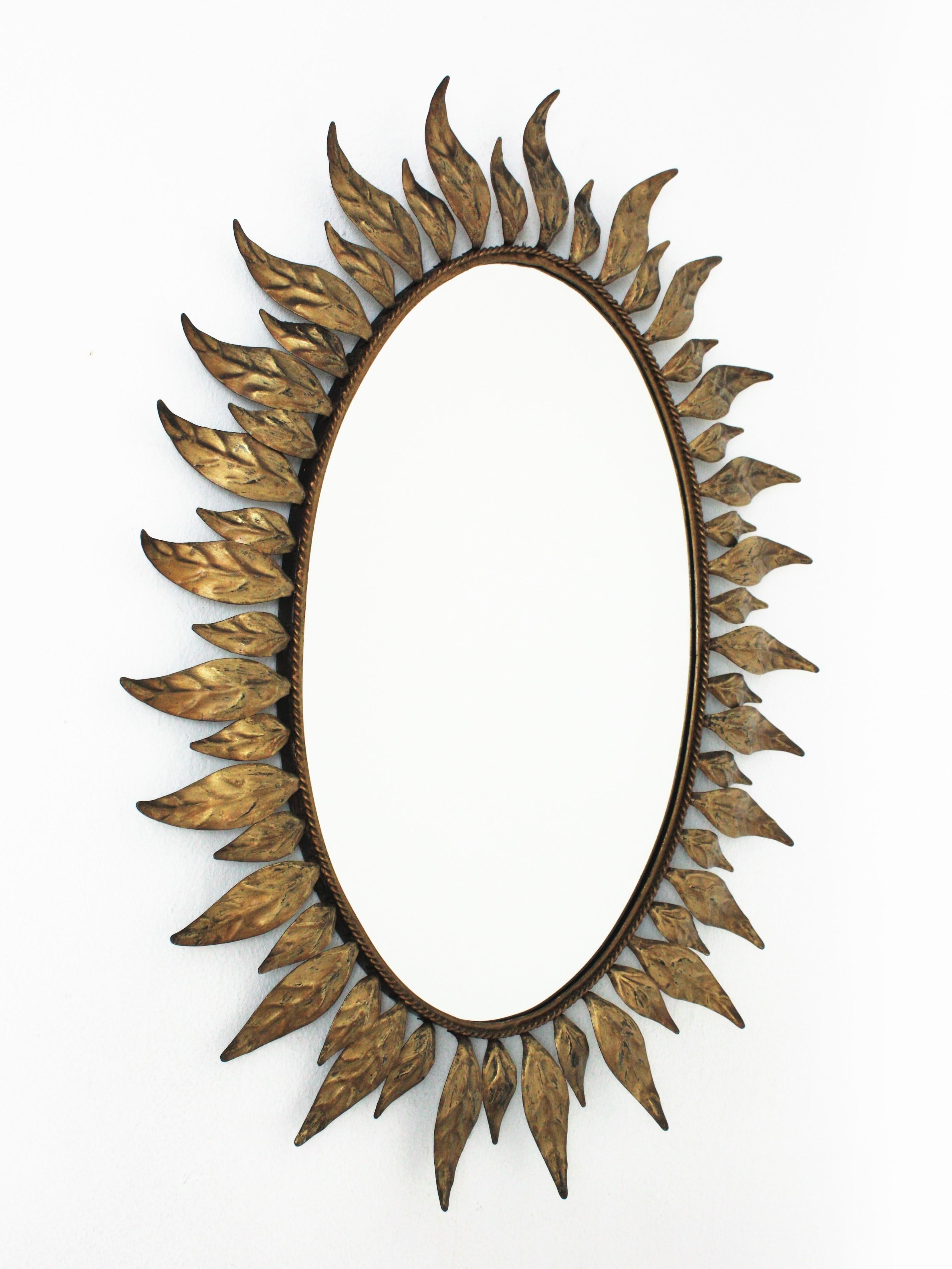 Mid-Century Modern Sunburst Oval Mirror in Gilt Metal with Leafed Frame For Sale