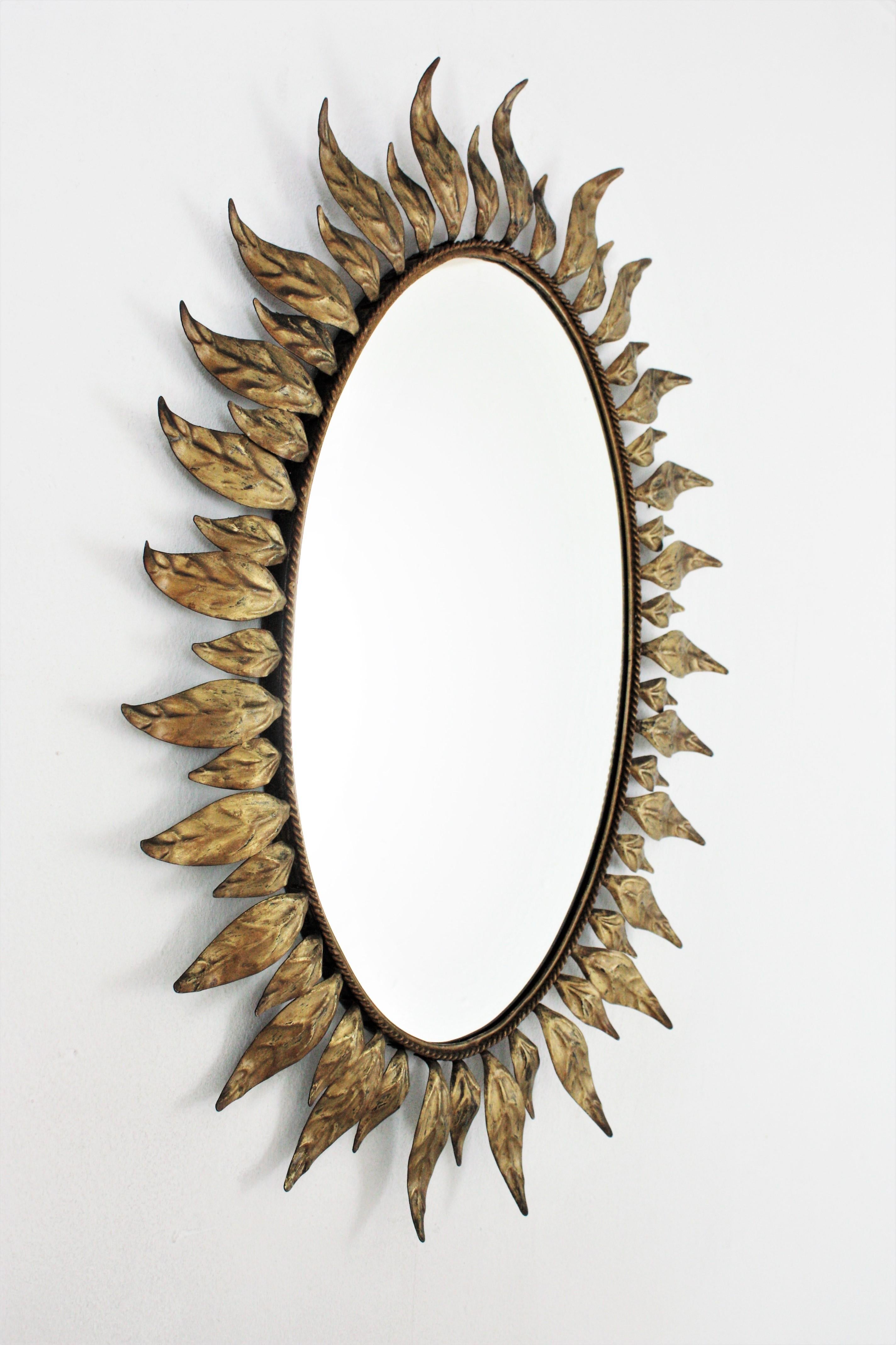 Spanish Sunburst Oval Mirror in Gilt Metal with Leafed Frame For Sale