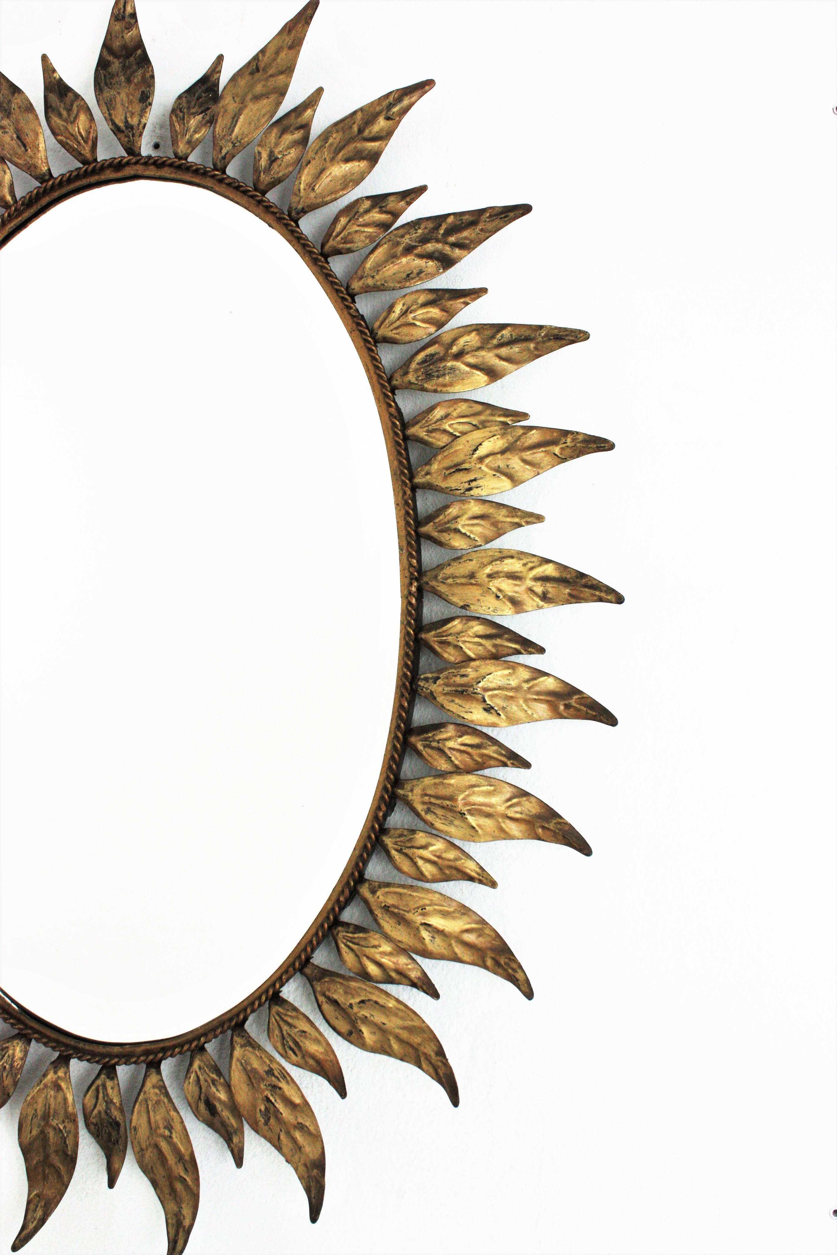 Sunburst Oval Mirror in Gilt Metal with Leafed Frame For Sale 1