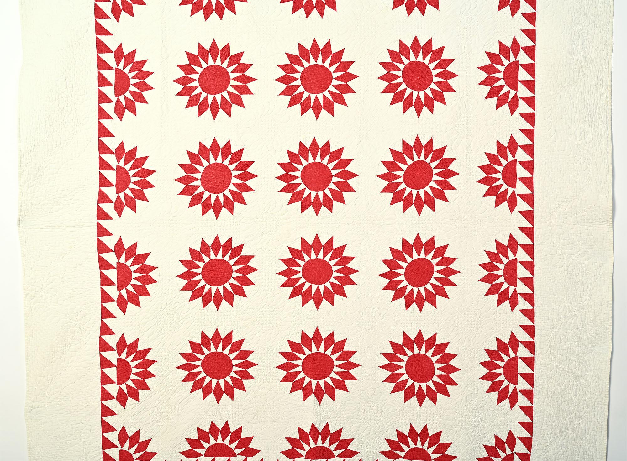 This Sunburst is especially well pieced and quilted. The red and white triangles come to the sharp points that one likes to see. Quilting is dense and done with a variety of patterns. There are checkerboards in the red circle centres and fine