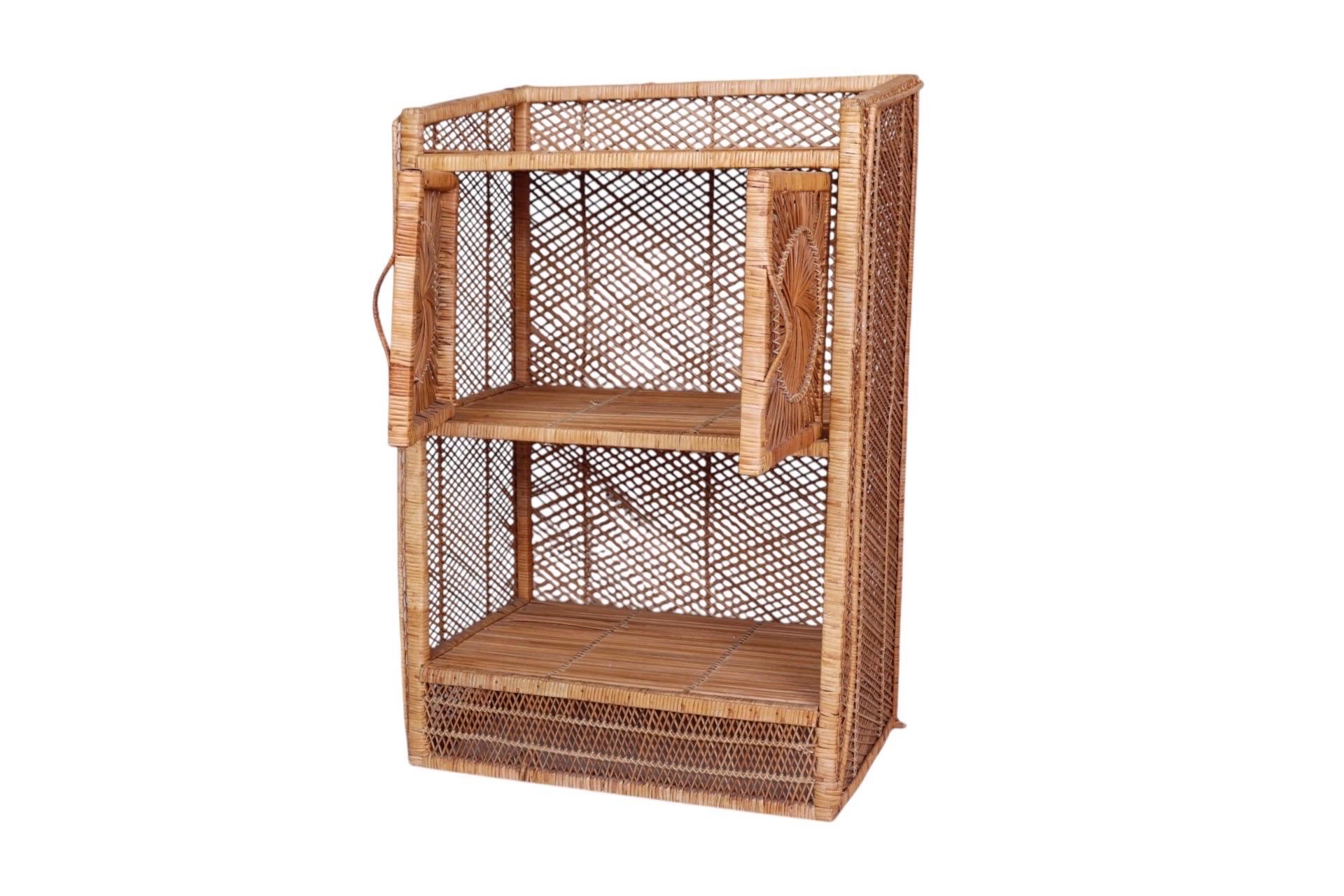 A coastal style rattan bar cabinet with sunburst design in front. A squared wooden frame is wrapped with woven rattan throughout, and the top shelf is trimmed with a braided gallery rail that flows down each side. The cabinet below opens with