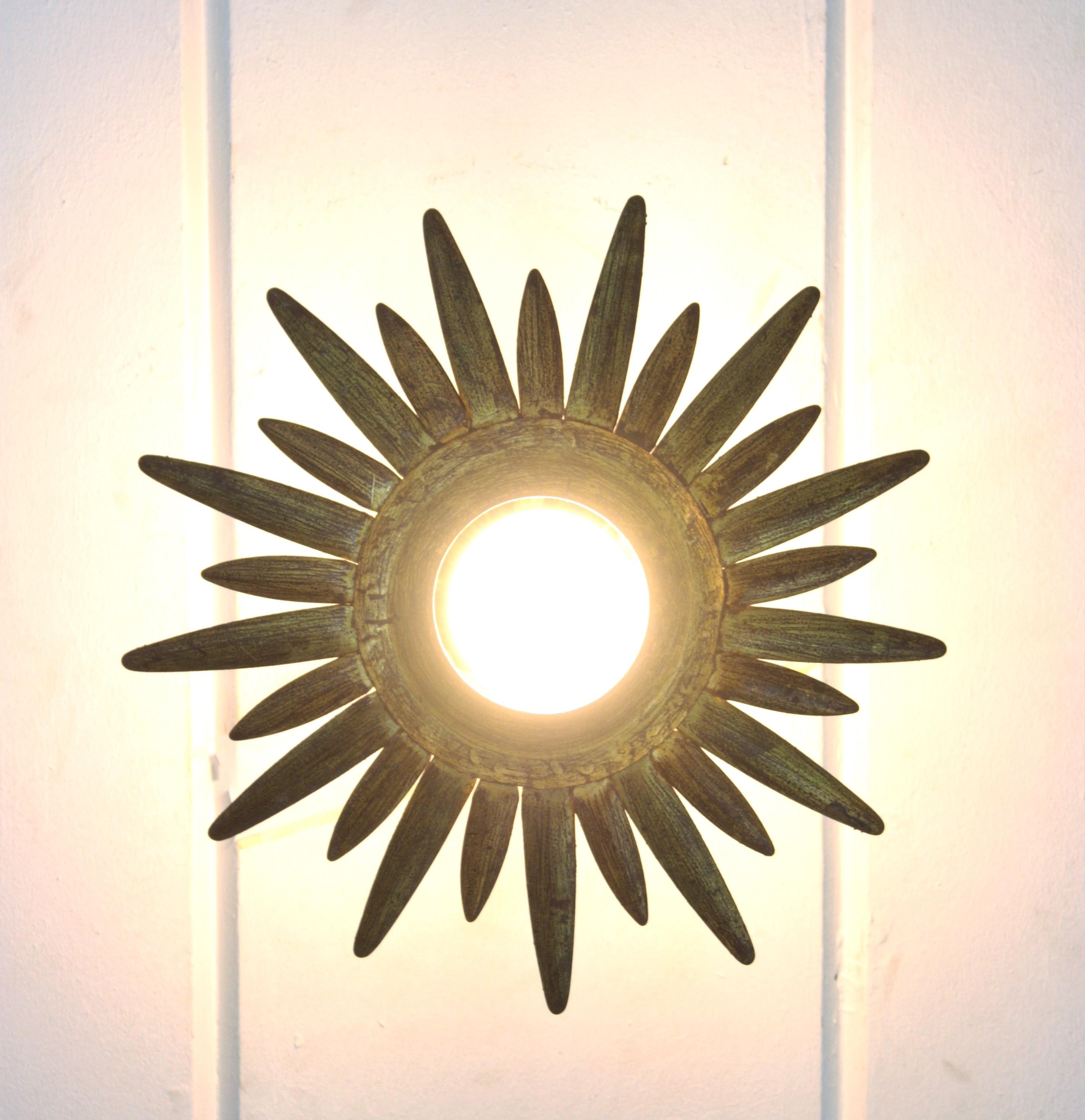 Patinated Sunburst Starburst Light Fixture in Gilt and Green Metal For Sale