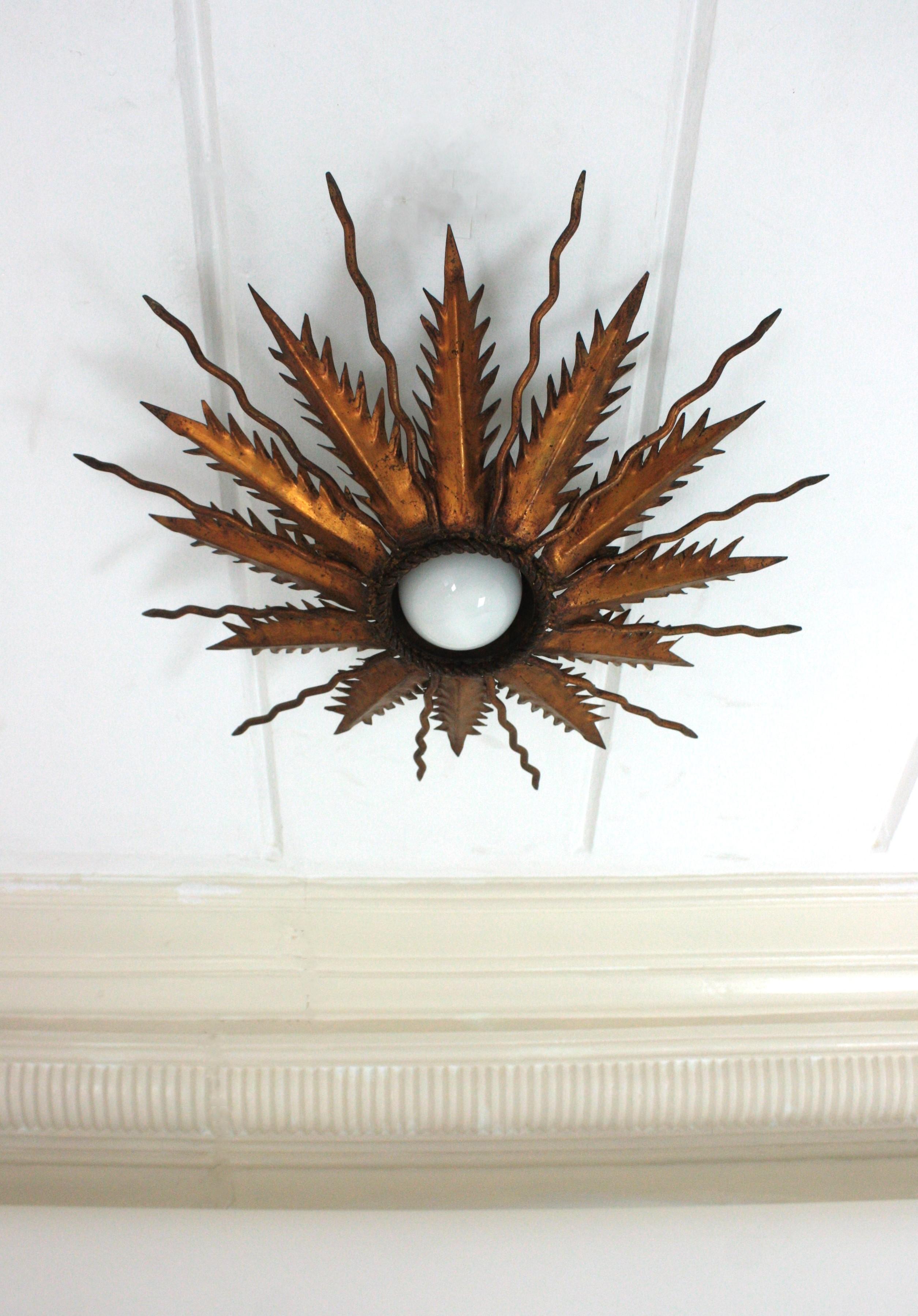French Sunburst Starburst Light Fixure in Bronze Gilt Wrought Iron, 1950 For Sale