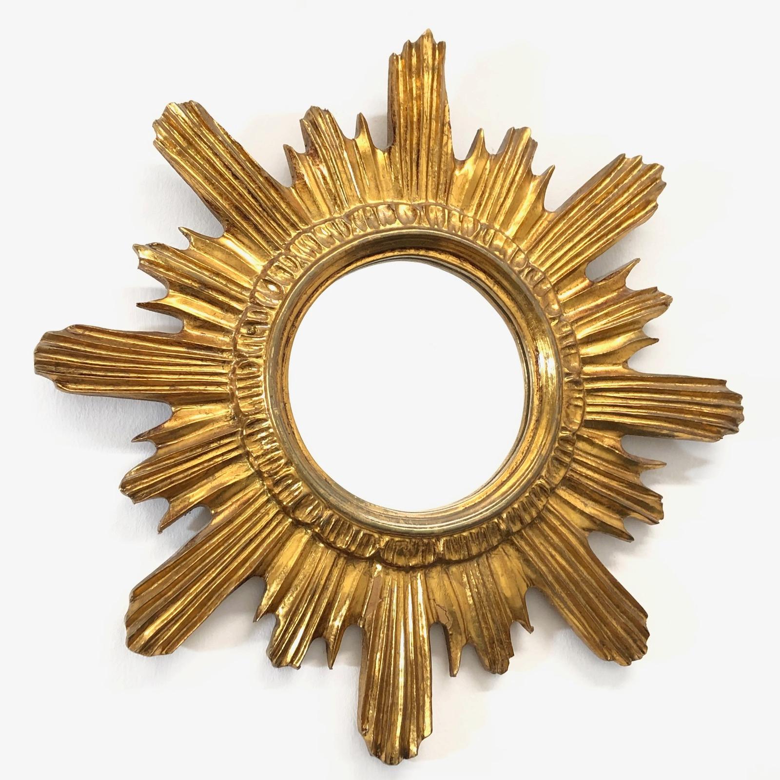 A gorgeous starburst mirror. Made of gilded wood and composition. No chips, no cracks, no repairs. It measures approximate 16 5/8