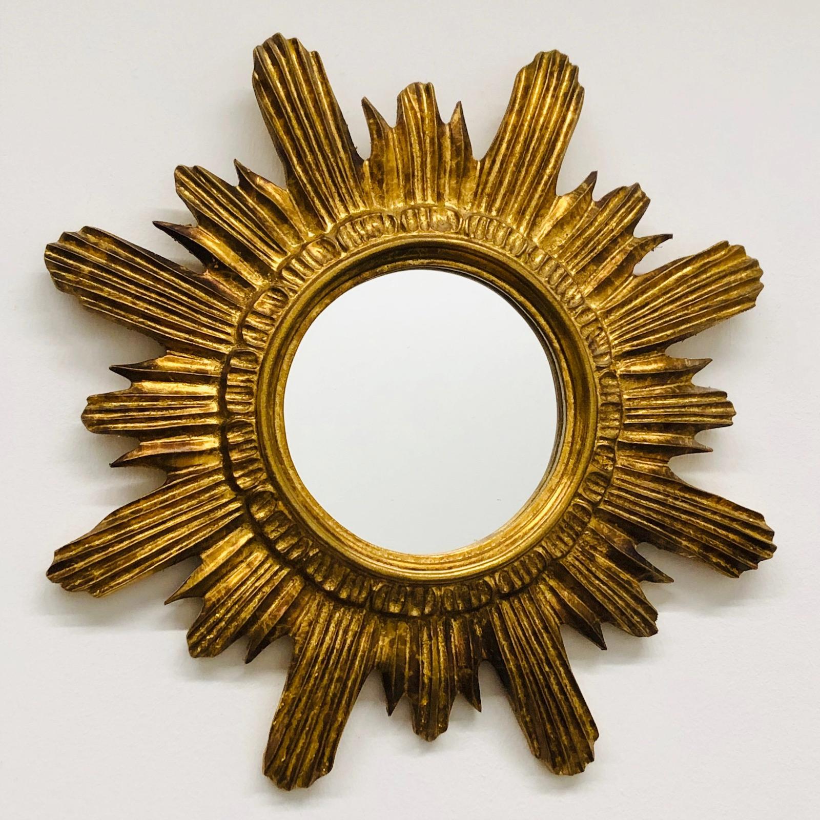 A gorgeous starburst mirror. Made of gilded wood and composition. No chips, no cracks, no repairs. It measures approximate 16 1/2