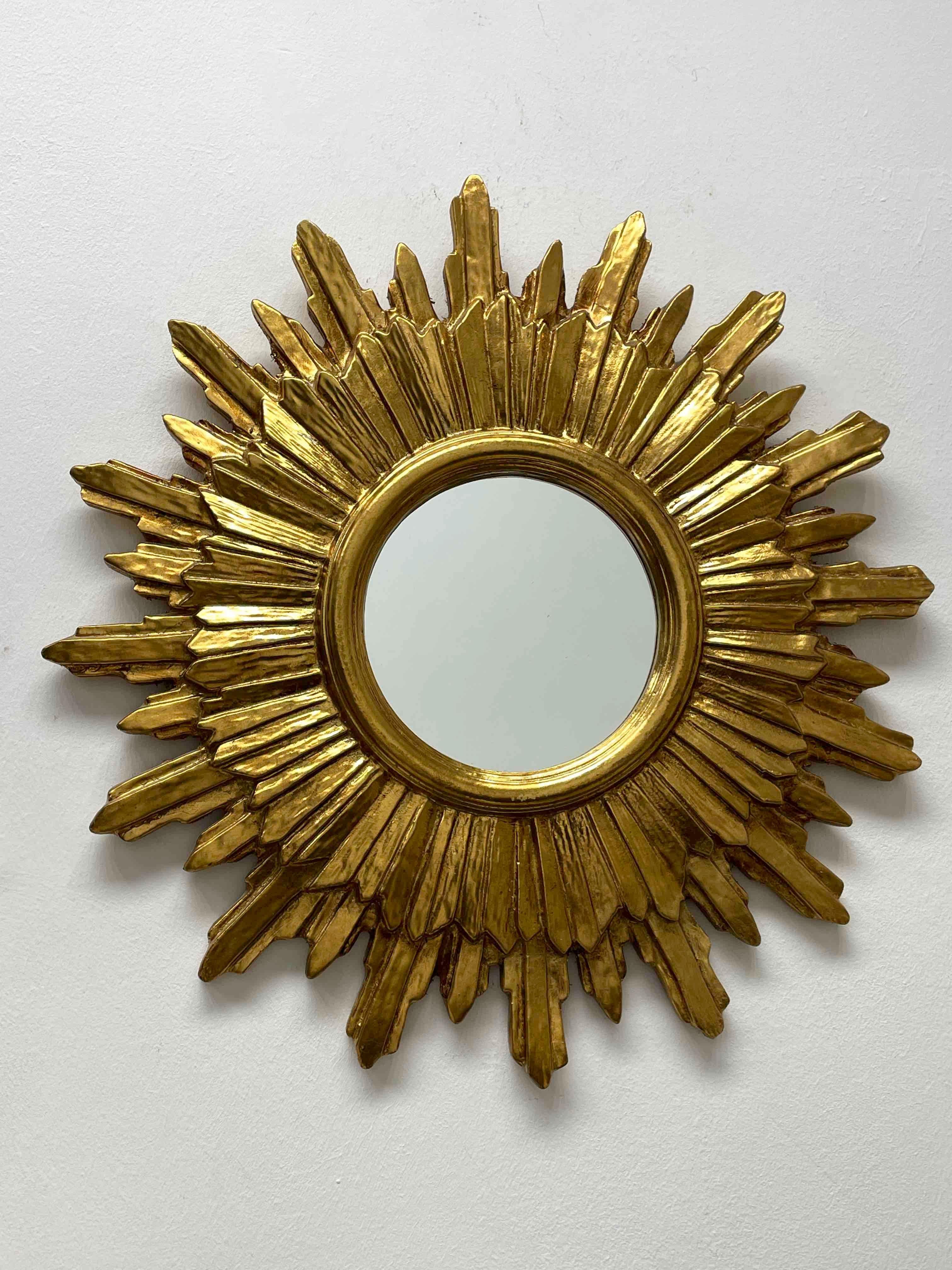 A gorgeous starburst mirror. Made of gilded wood and composition. No chips, no cracks, no repairs. It measures approximate: 20