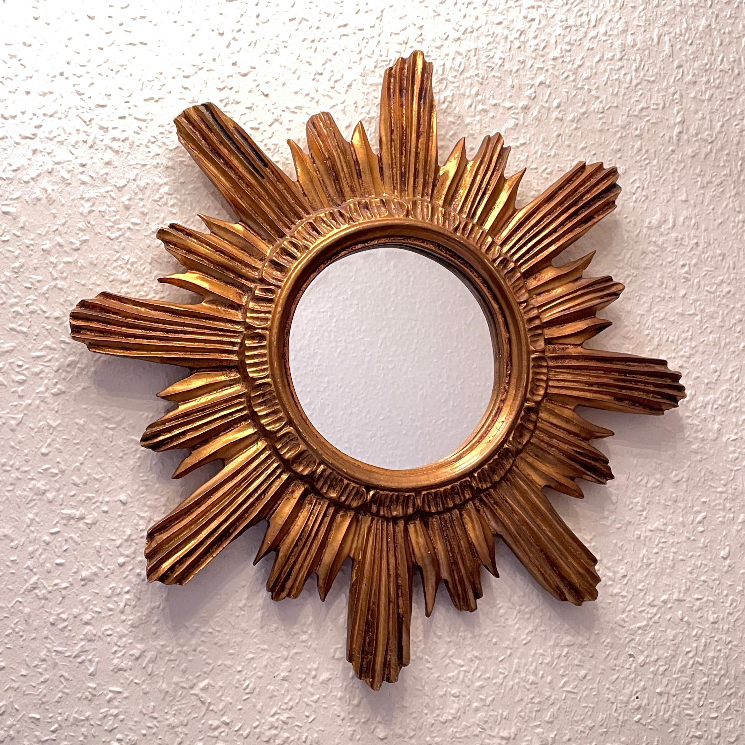 A gorgeous starburst mirror. Made of gilded wood and stucco. No chips, no cracks, no repairs. It measures approximate: 18.63