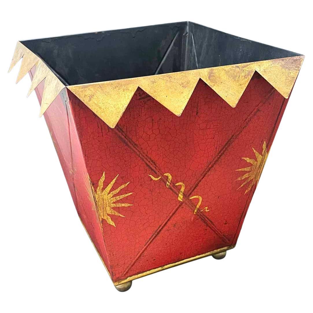 Commissioned by Briger Design and made by Mexican artisans in San Miguel de Allende, this painted tole wastebasket is entirely charming and winning.  The flaring sides of the piece are painted with sunburst and fluttering ribbon designs in an