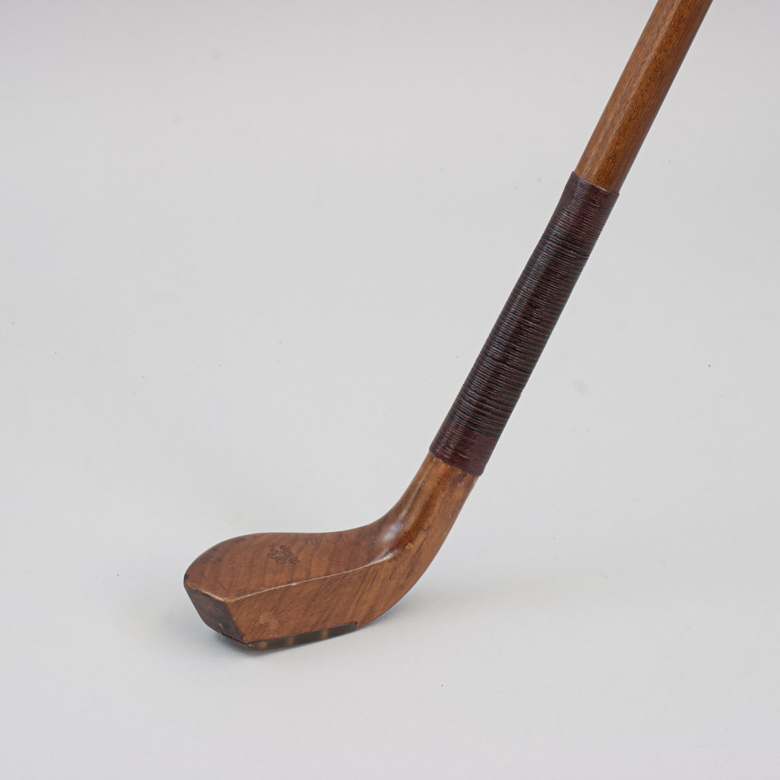 Antique Sunday Club, Golf Club Walking Stick.
A desirable walking cane with the handle in the shape of a golf club head. The gentleman's walking stick has a persimmon scared head handle with horn sole insert and a lead weight to the rear. The crown